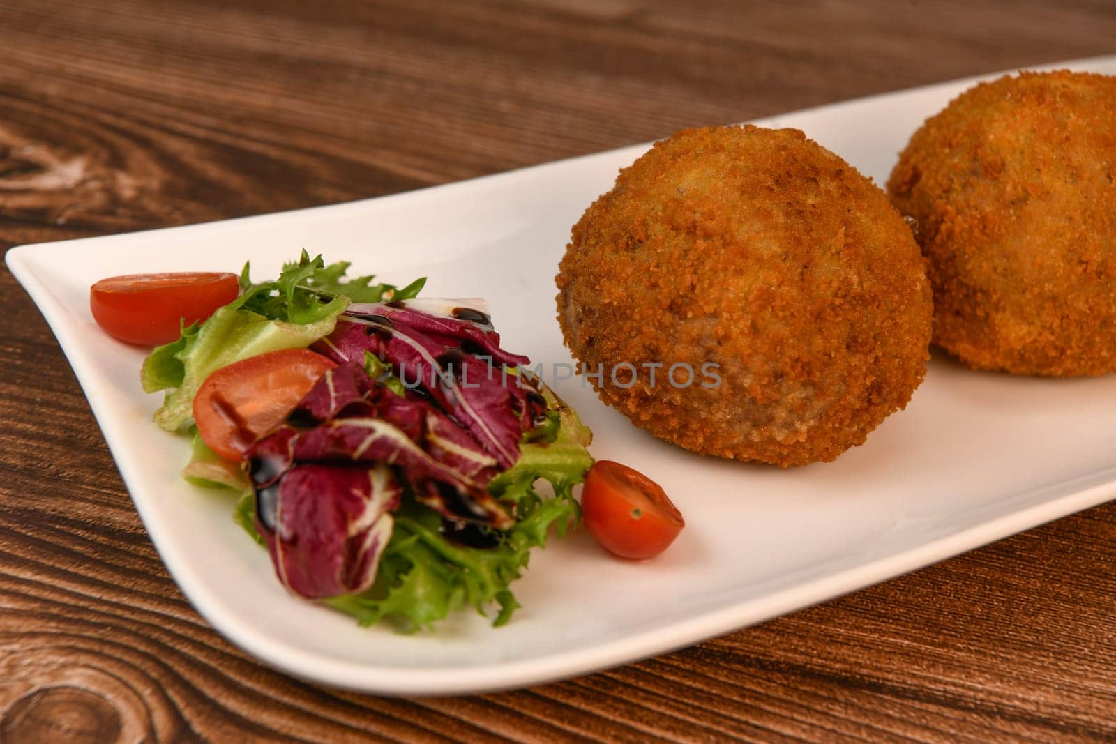 RECIPE FOR BREADED BEEF MEATBALLS STUFFED WITH A SOFT BOILED EGG. High quality photo