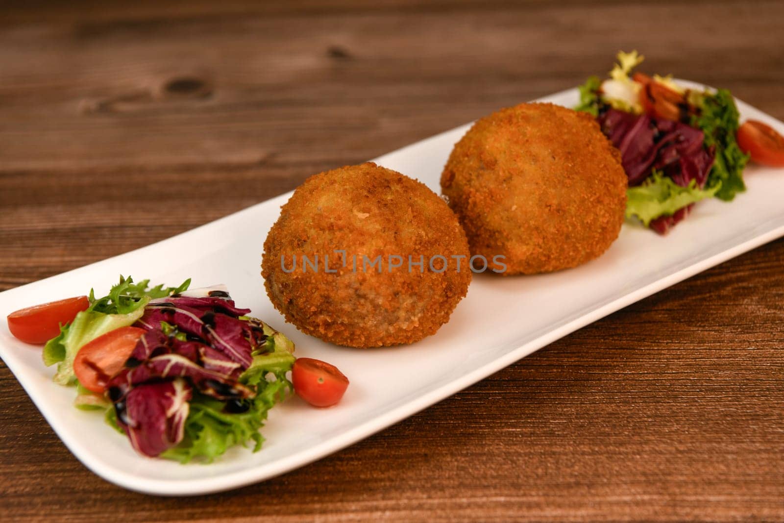 RECIPE FOR BREADED BEEF MEATBALLS STUFFED WITH A SOFT BOILED EGG. High quality photo
