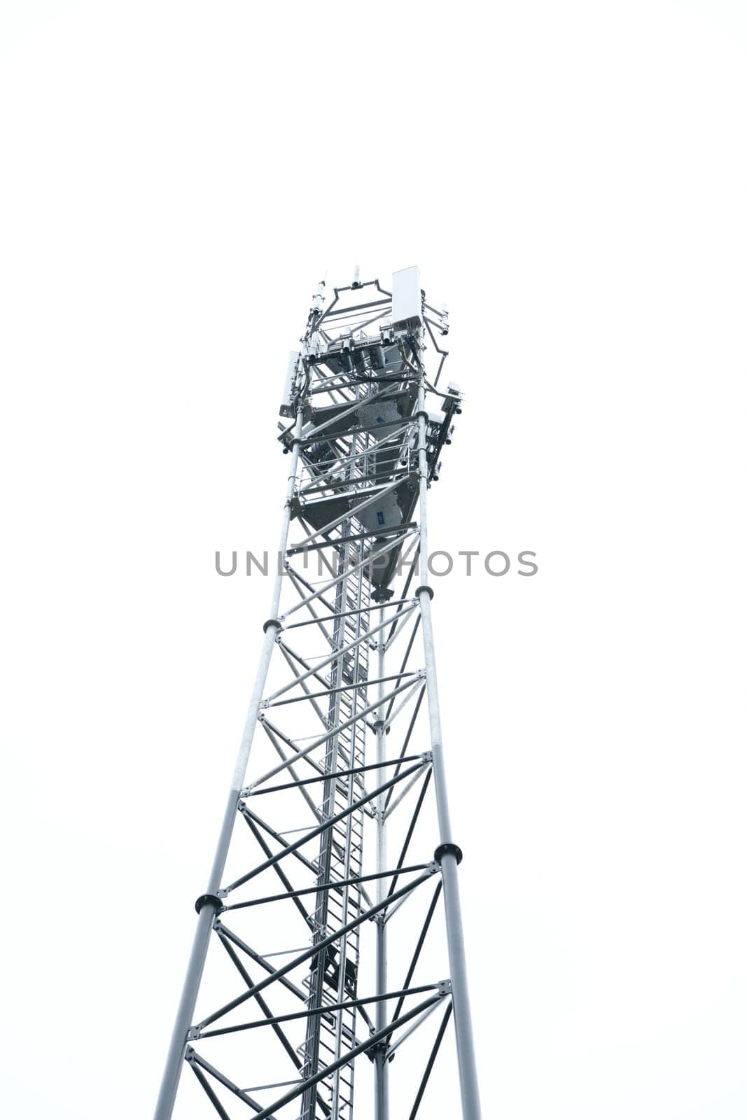 Deployment of the 5G network. Laying antennas on a mobile phone mast in the winter atmosphere. France, Gironde, February 2024. High quality photo