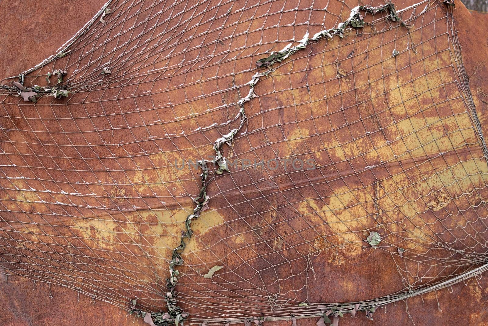 Background of rusty metal texture with old torn net