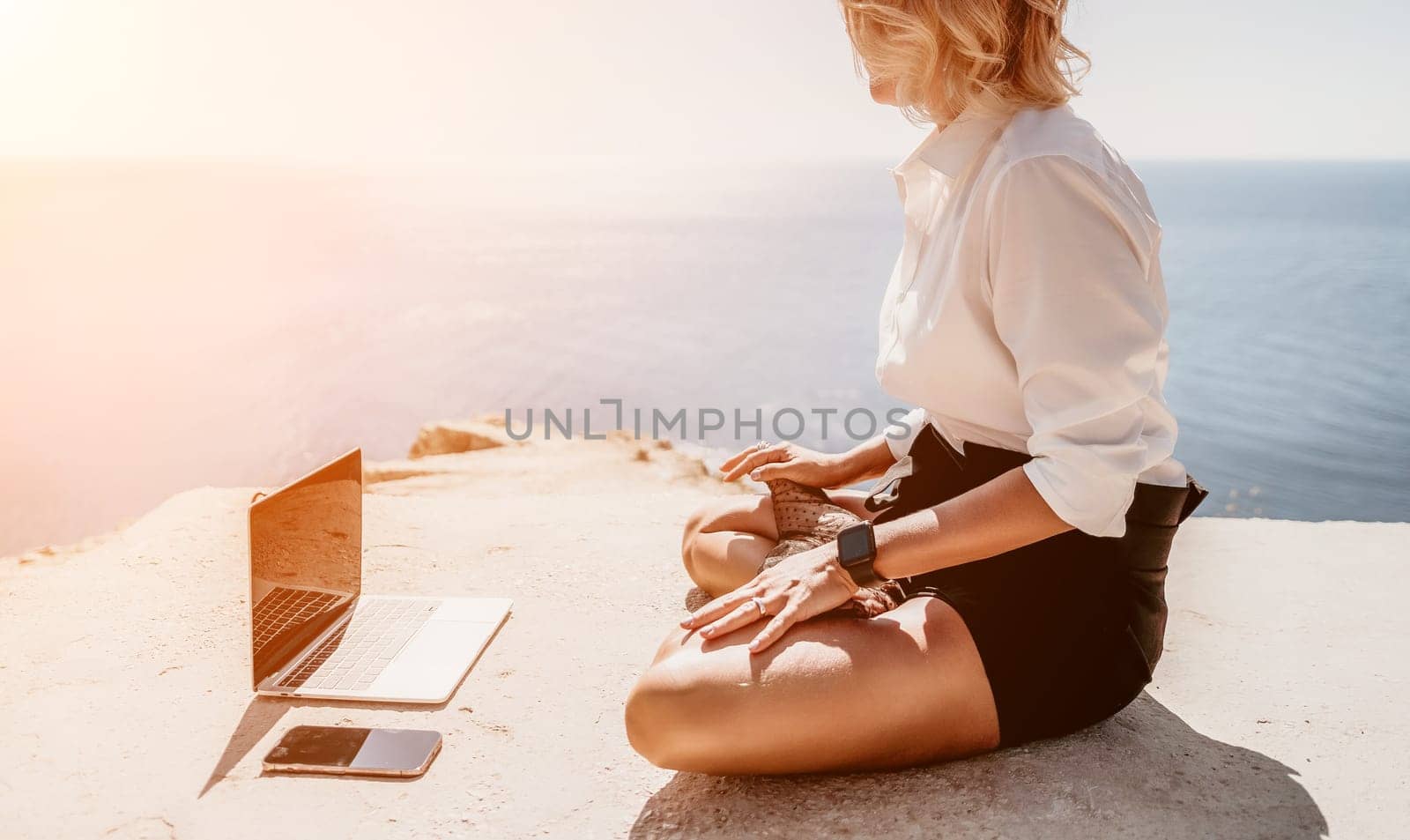 Woman sea laptop yoga. Business woman freelancer in yoga pose working over blue sea beach at laptop and meditates. Girl relieves stress from work. Freelance, digital nomad, travel and holidays concept by panophotograph