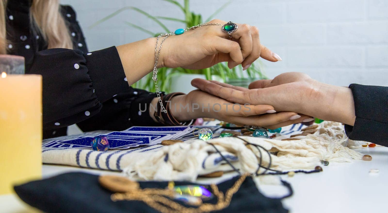 A fortune teller reads with tarot cards. Selective focus. Woman.