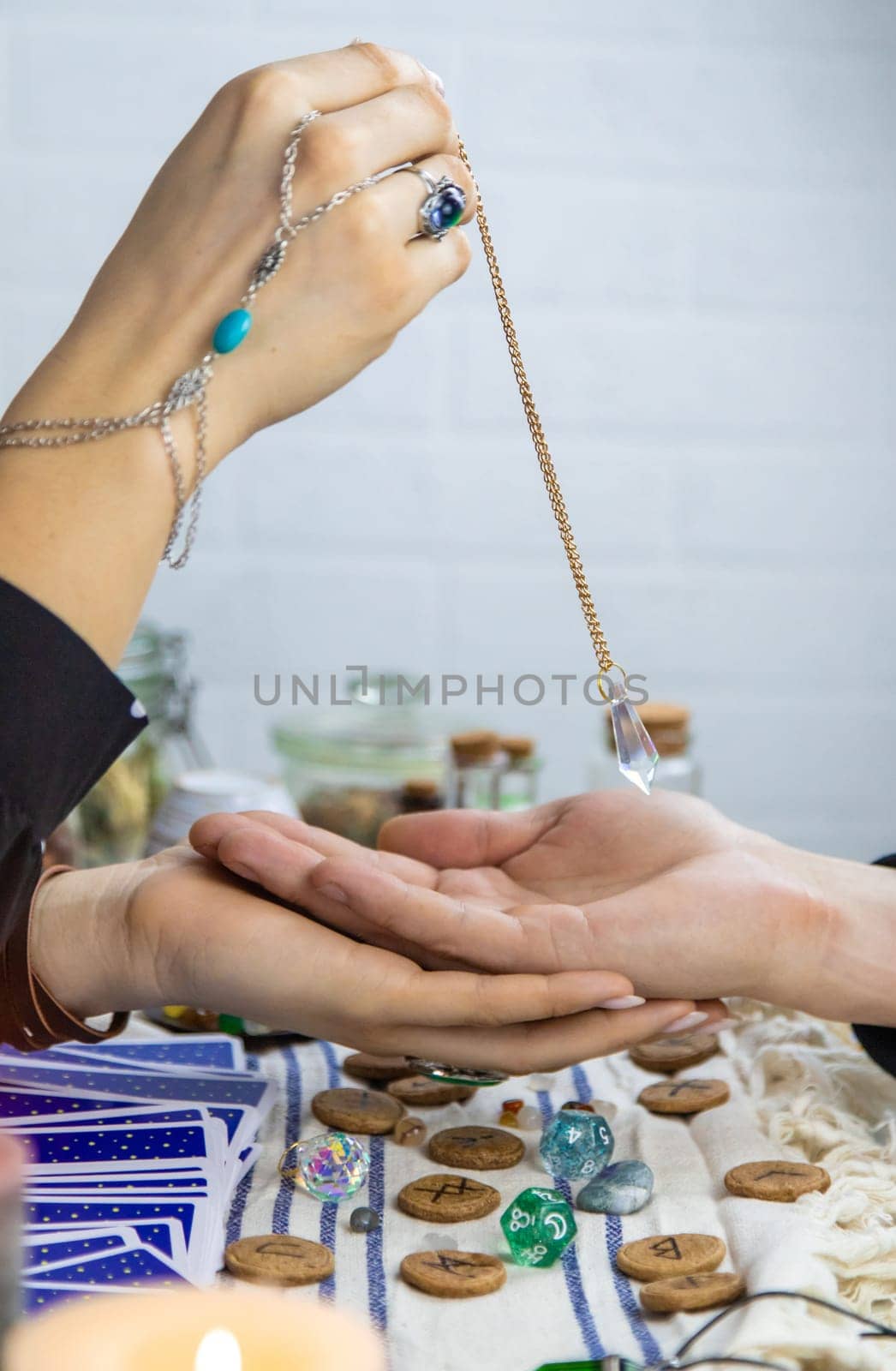 A fortune teller reads with tarot cards. Selective focus. Woman.