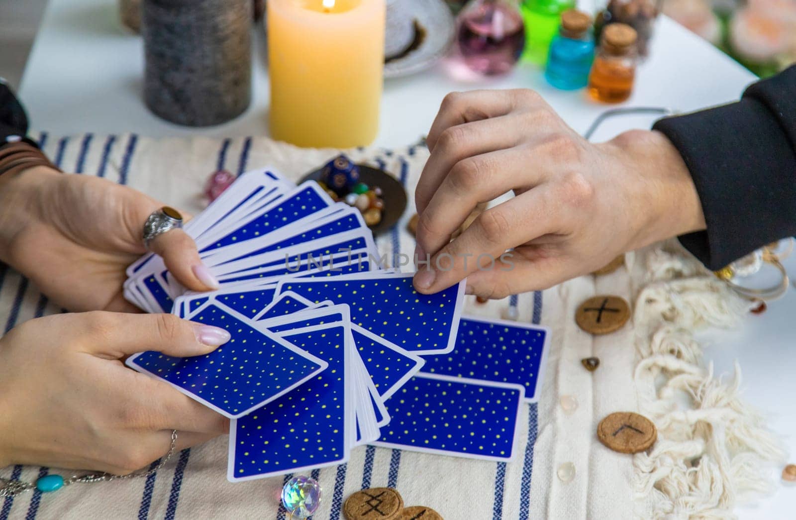 A woman fortuneteller tells a man on tarot cards. Selective focus. People.