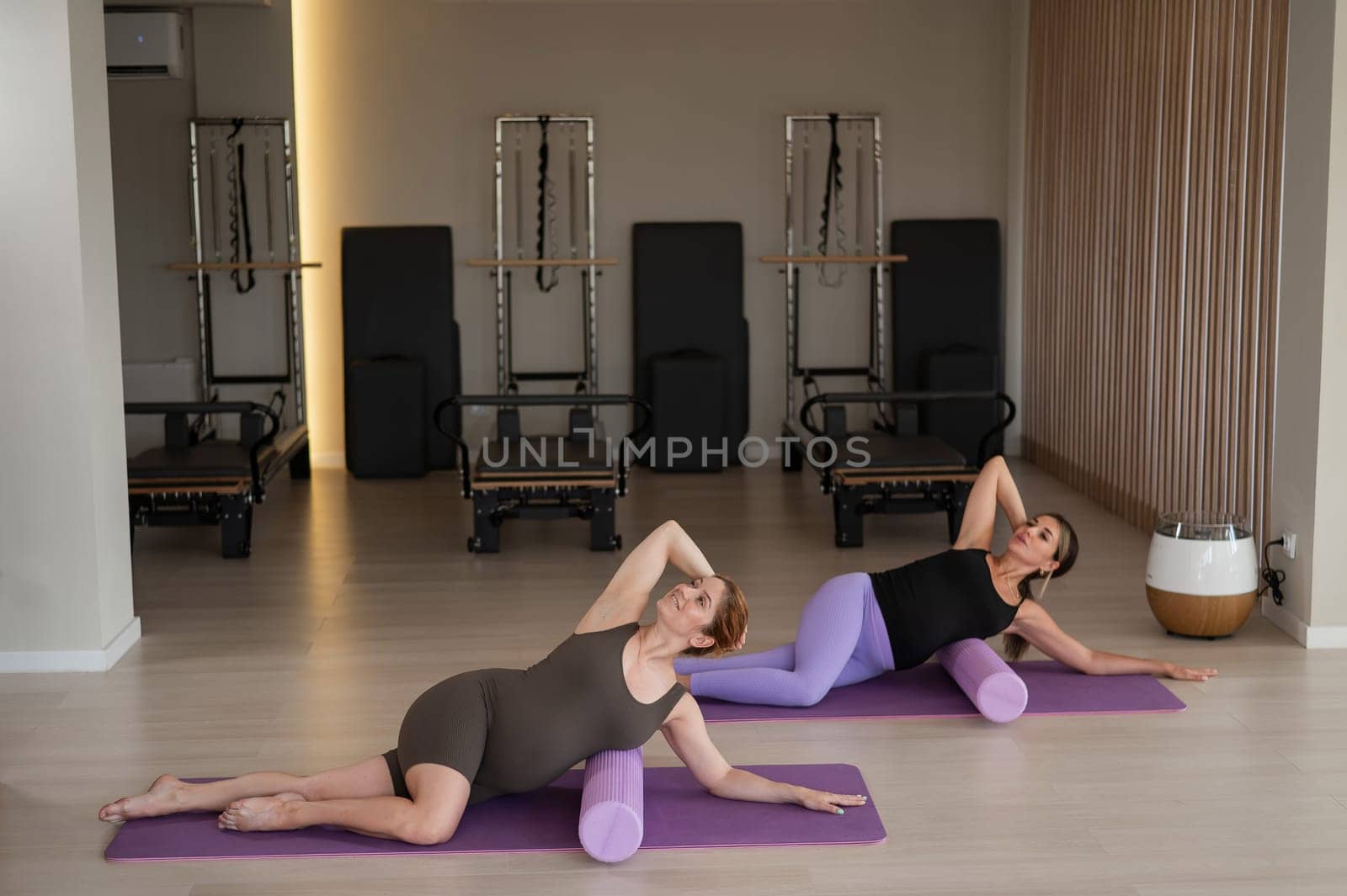Two pregnant women doing yoga. Preparing for the birth of a child