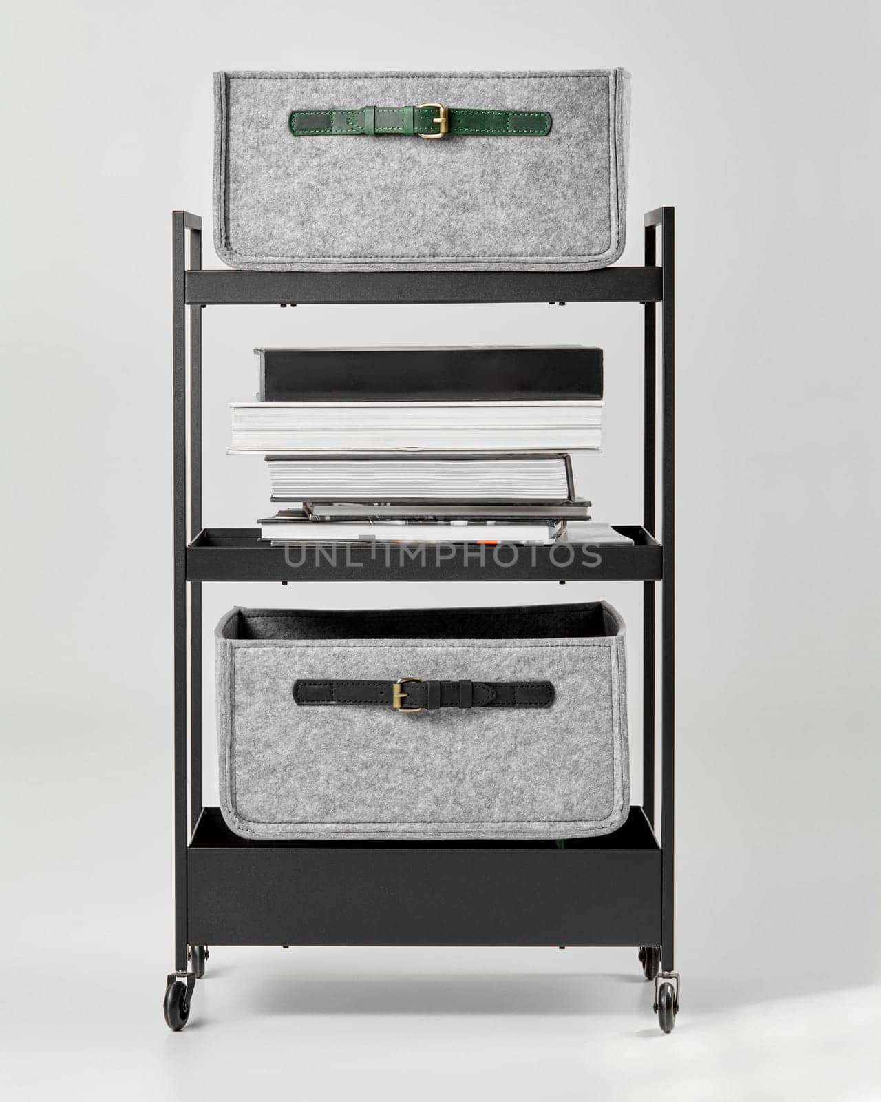 Office trolley with gray felt storage drawers and books on shelves by nazarovsergey