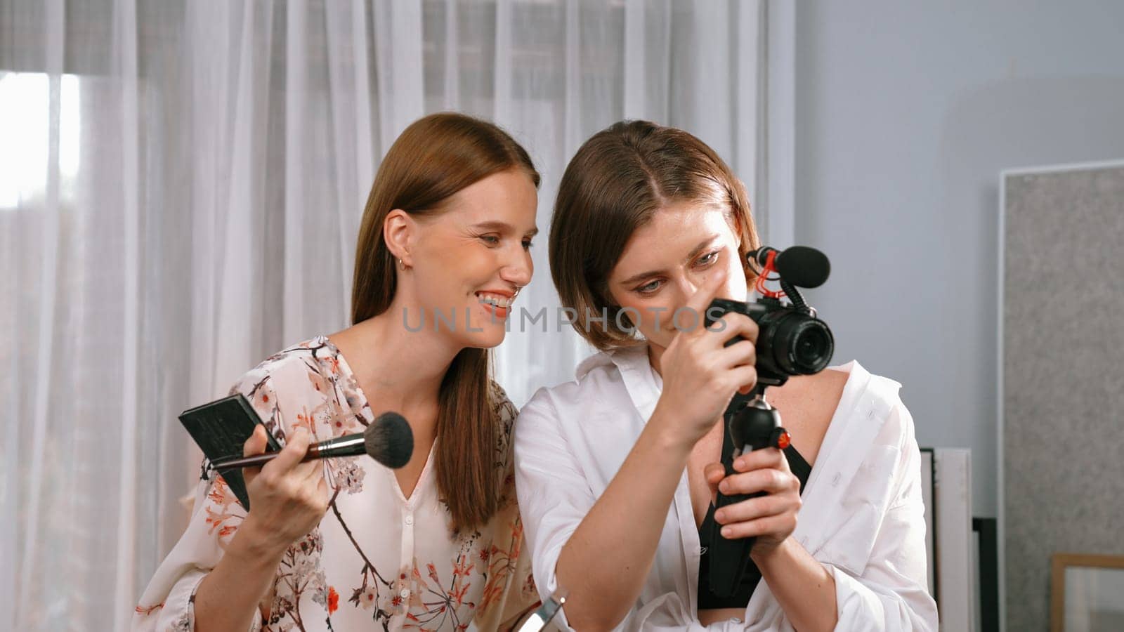 Two influencer partner shoot live streaming vlog video review makeup prim social media or blog. Happy young girl with cosmetics studio lighting for marketing recording session broadcasting online.