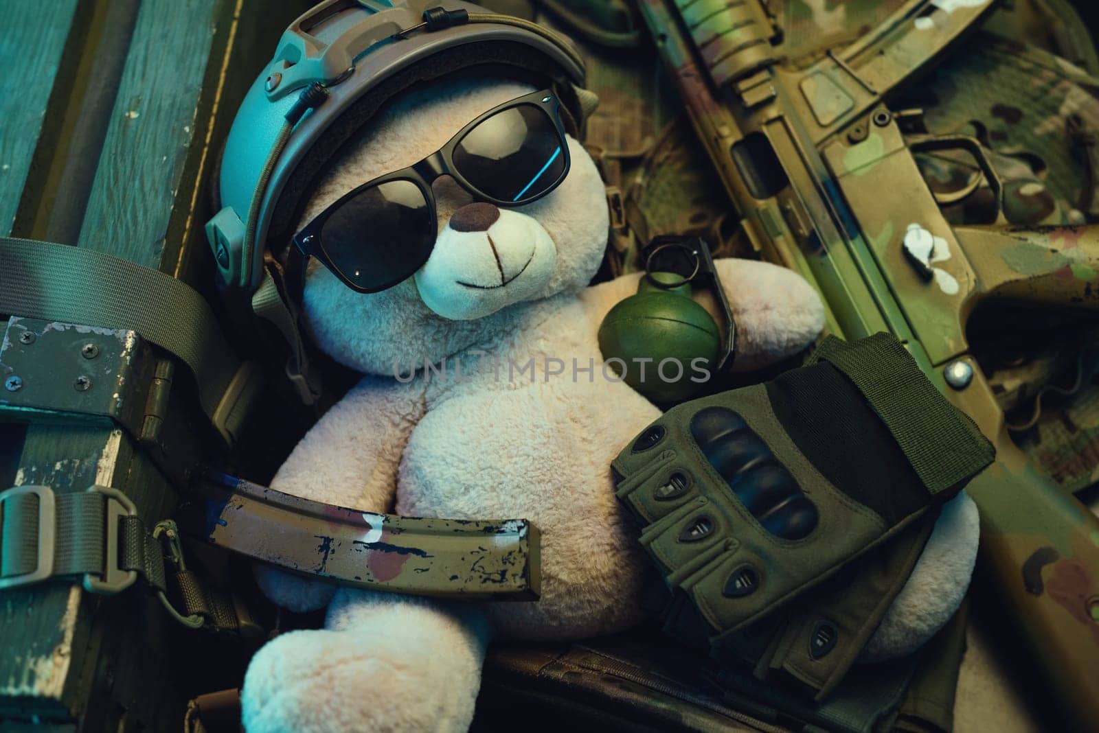 A teddy bear in a military helmet among a pile of military ammunition, a rifle, grenades, a bulletproof vest, a helmet and other tactical airsoft items by Rotozey