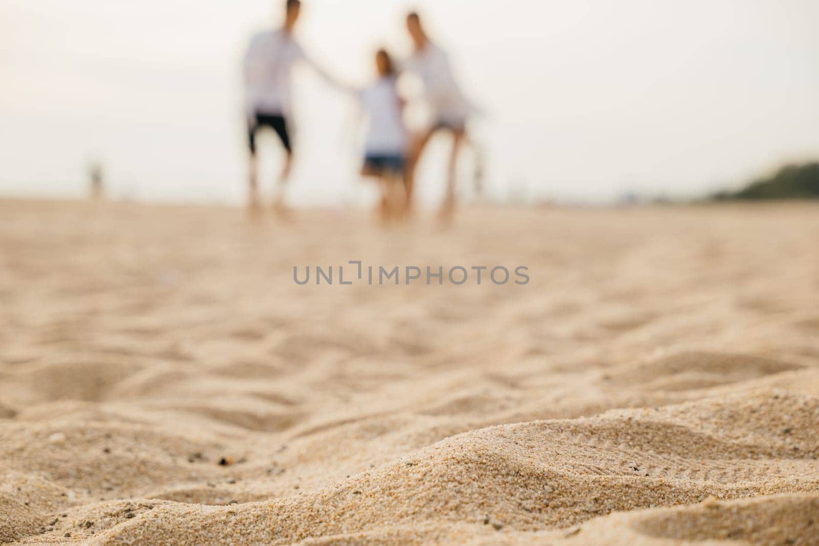 Running on the beach a joyful family with happy parents and children. Laughter play and joy during their summer holiday. Carefree moments of family bonding and happiness. Family on beach vacation by Sorapop