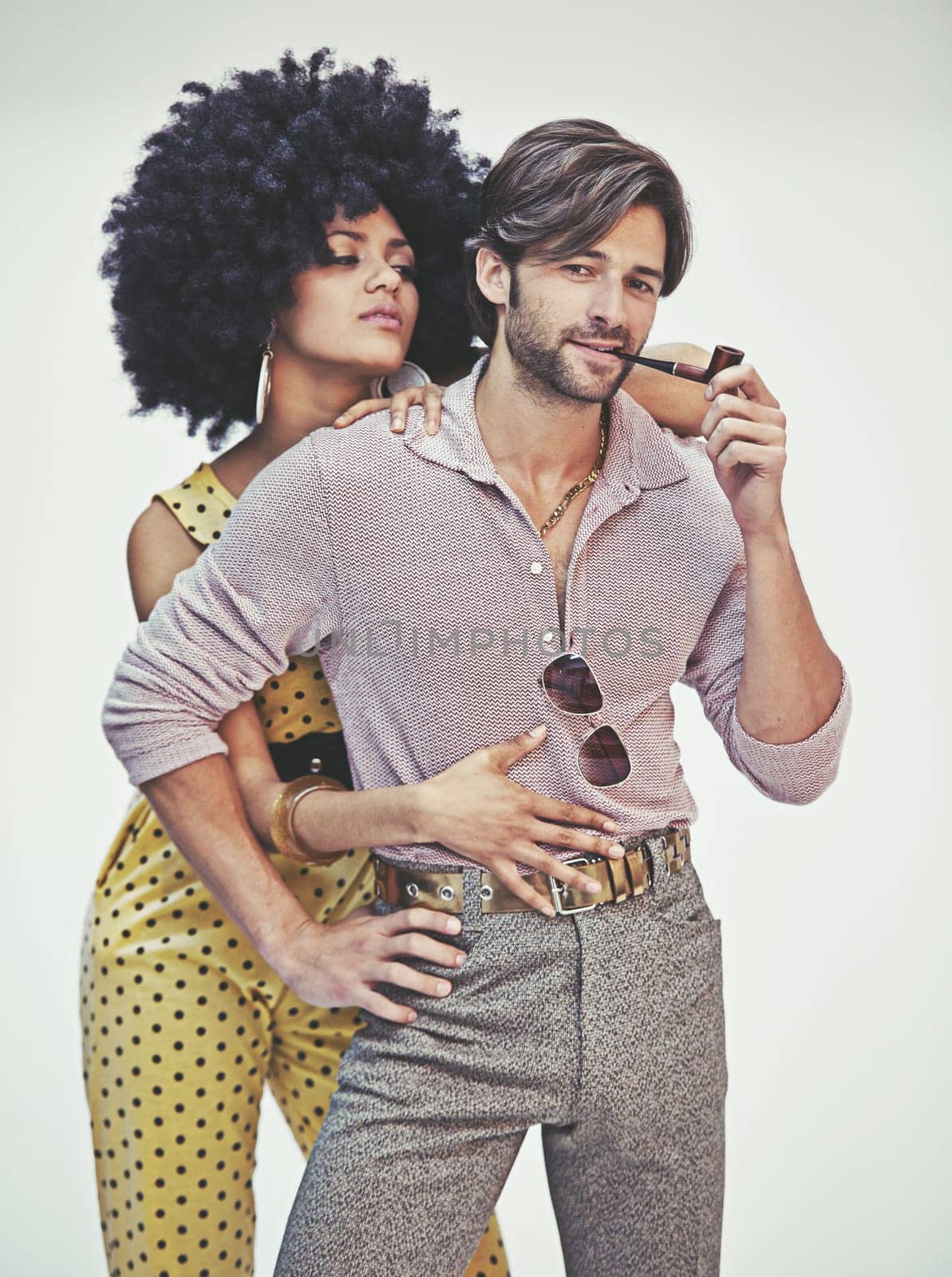Couple, portrait and fashion with pipe for smoking, style or outfit on a gray studio background. Young interracial man, woman or smoker in stylish pants, shirt or jumpsuit with jewelry or accessories.