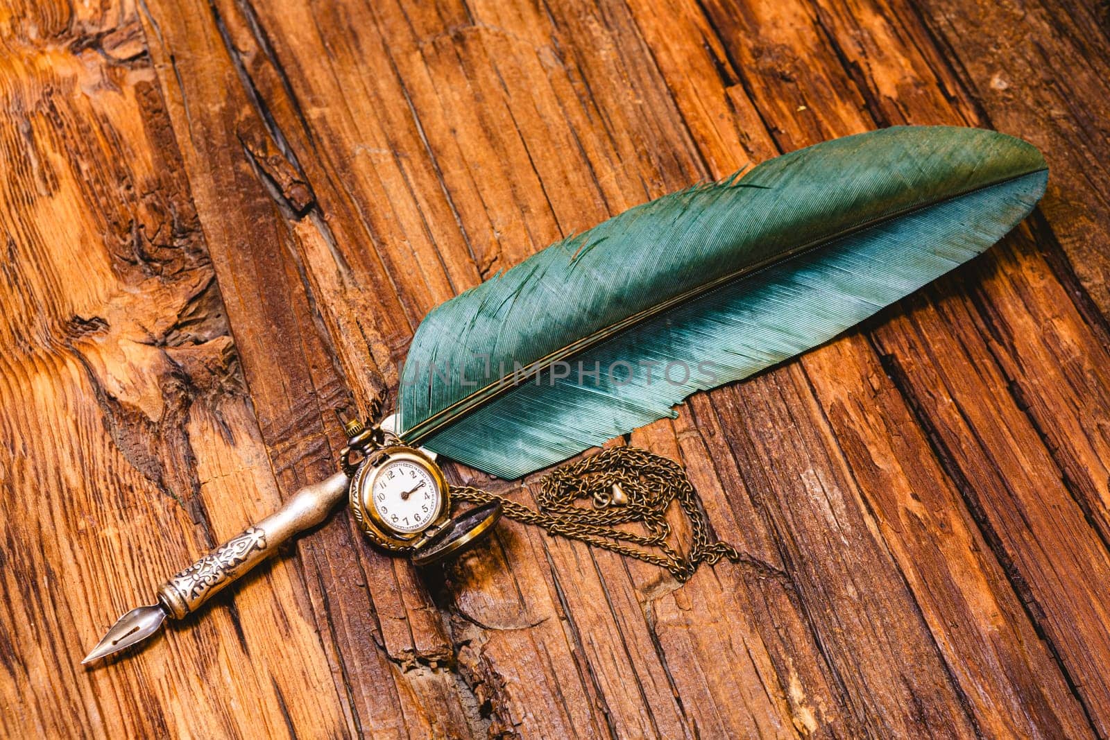 Old quill pen on wooden desk in the old office . Retro style. Conceptual background on history, education, literature topics. by sarymsakov