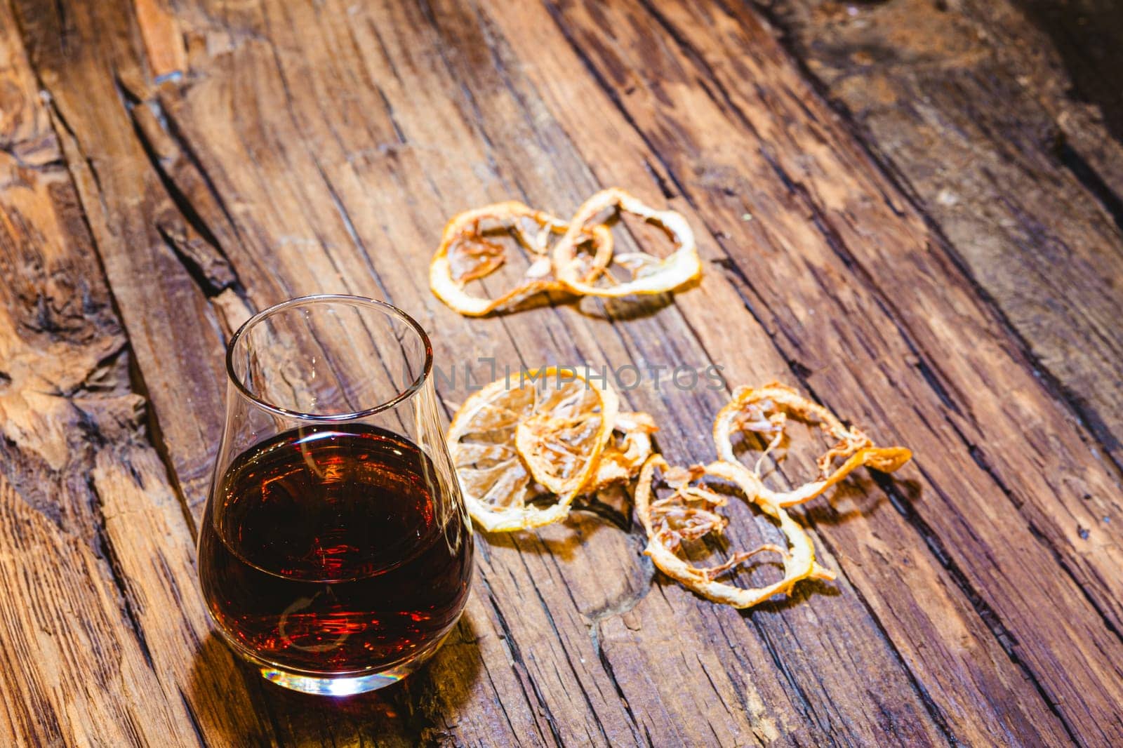 Close Up of a Glass of Sweet Madeira Fortified Wine on wooden table.