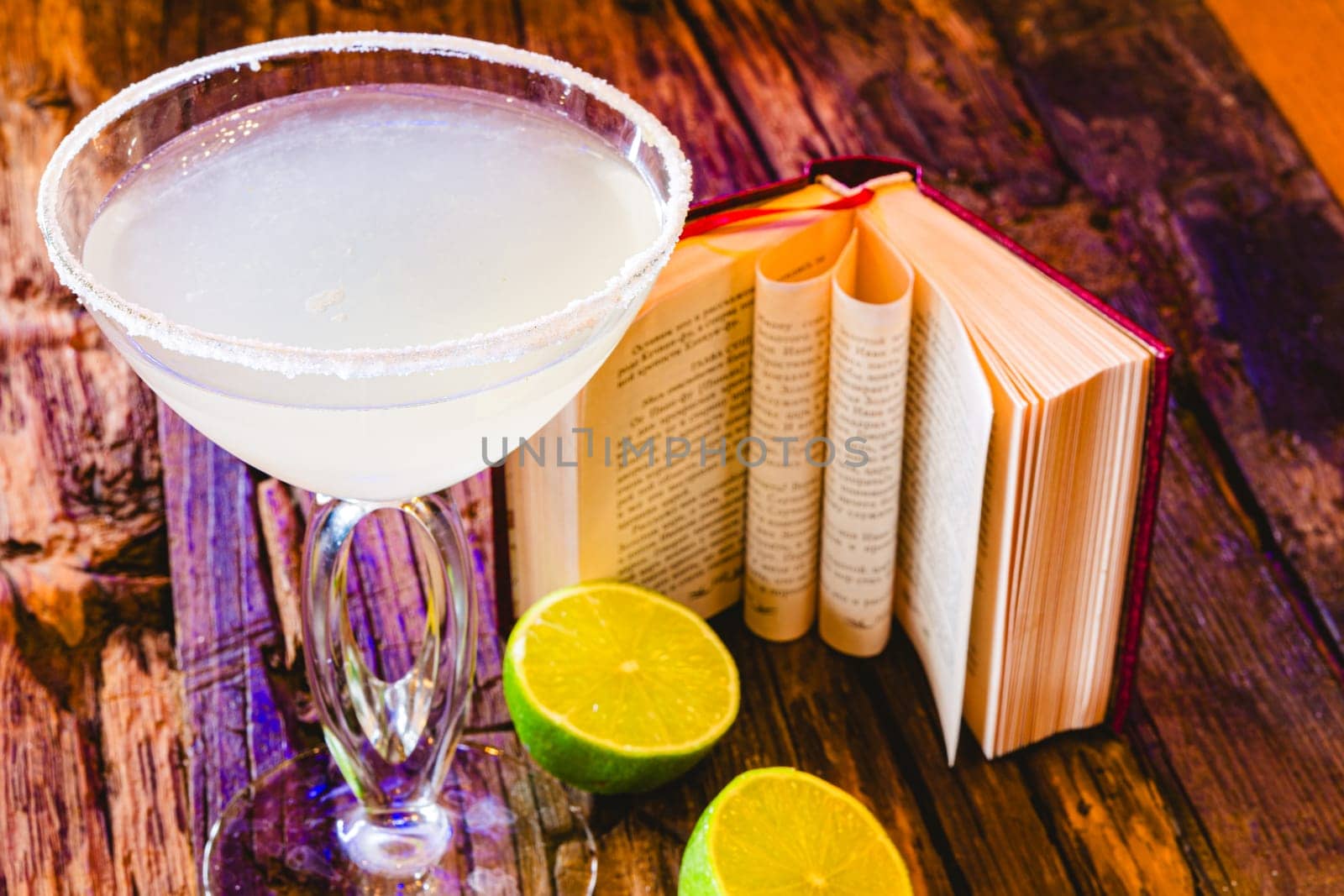 Margarita cocktail with lime in a glass on wooden table. Shallow dof.