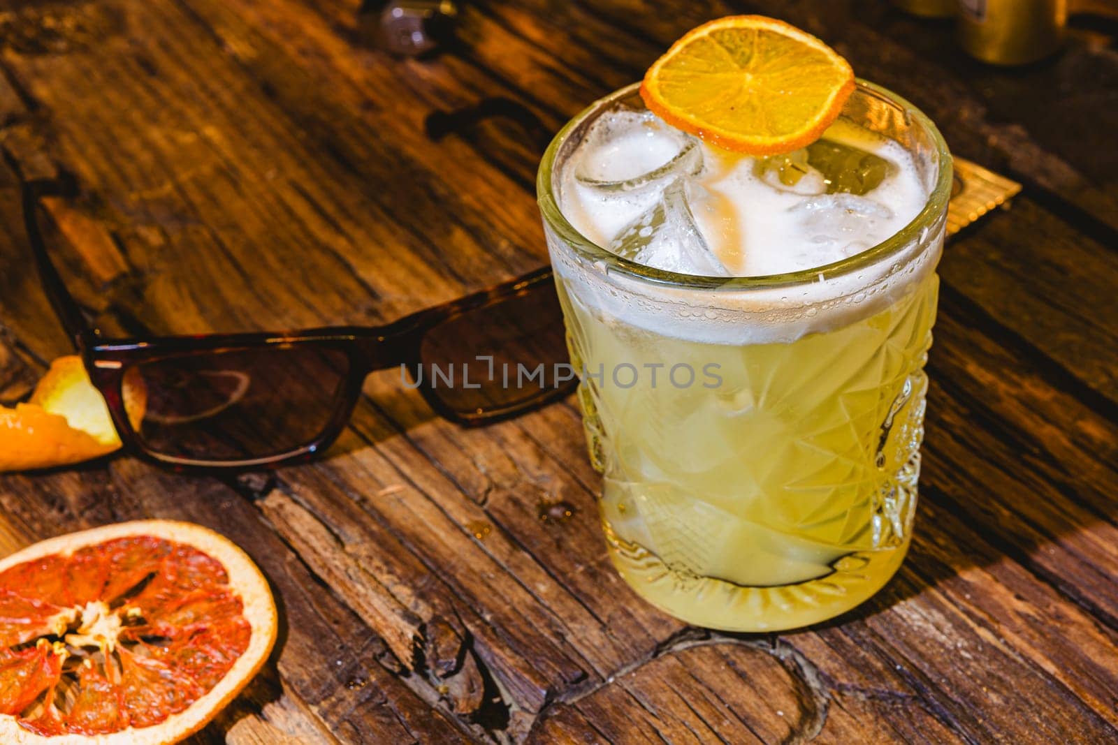 Whiskey Sour Drink Lighting on wooden table. Shallow dof