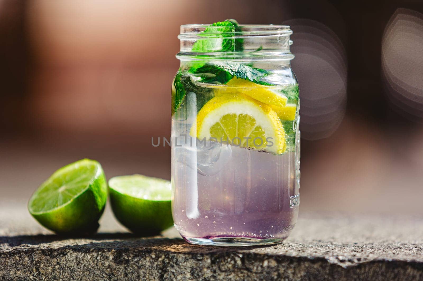 Glass of lime lemonade. Summer refreshing drinks. Homemade lemonade with lime and orange. Cold drinks