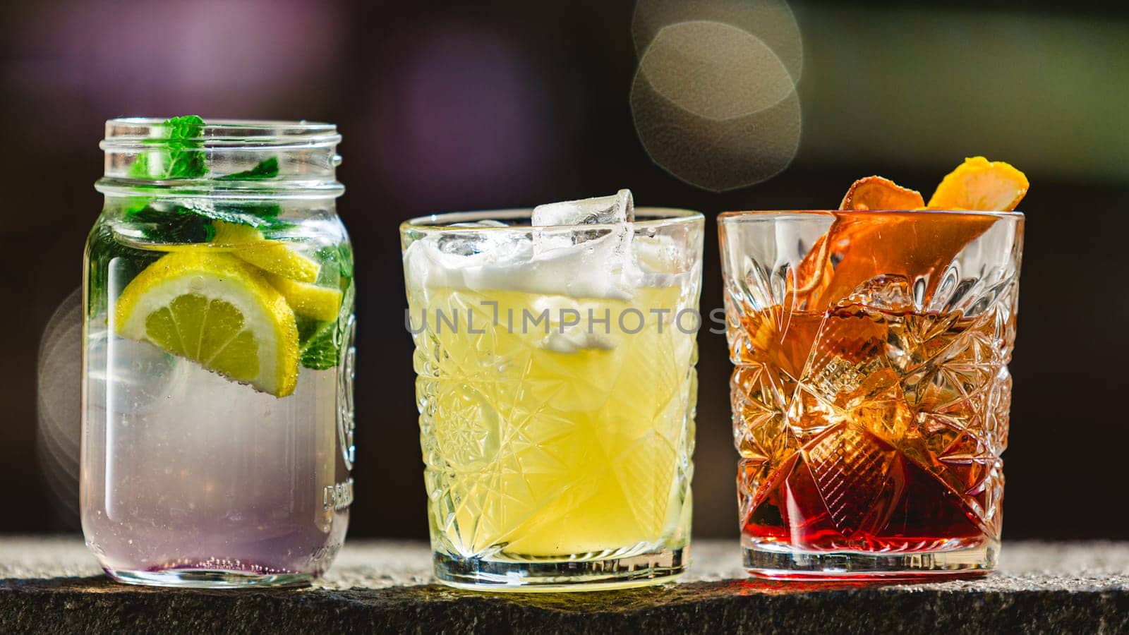 three different alcoholic cocktails with old-fashioned glasses.