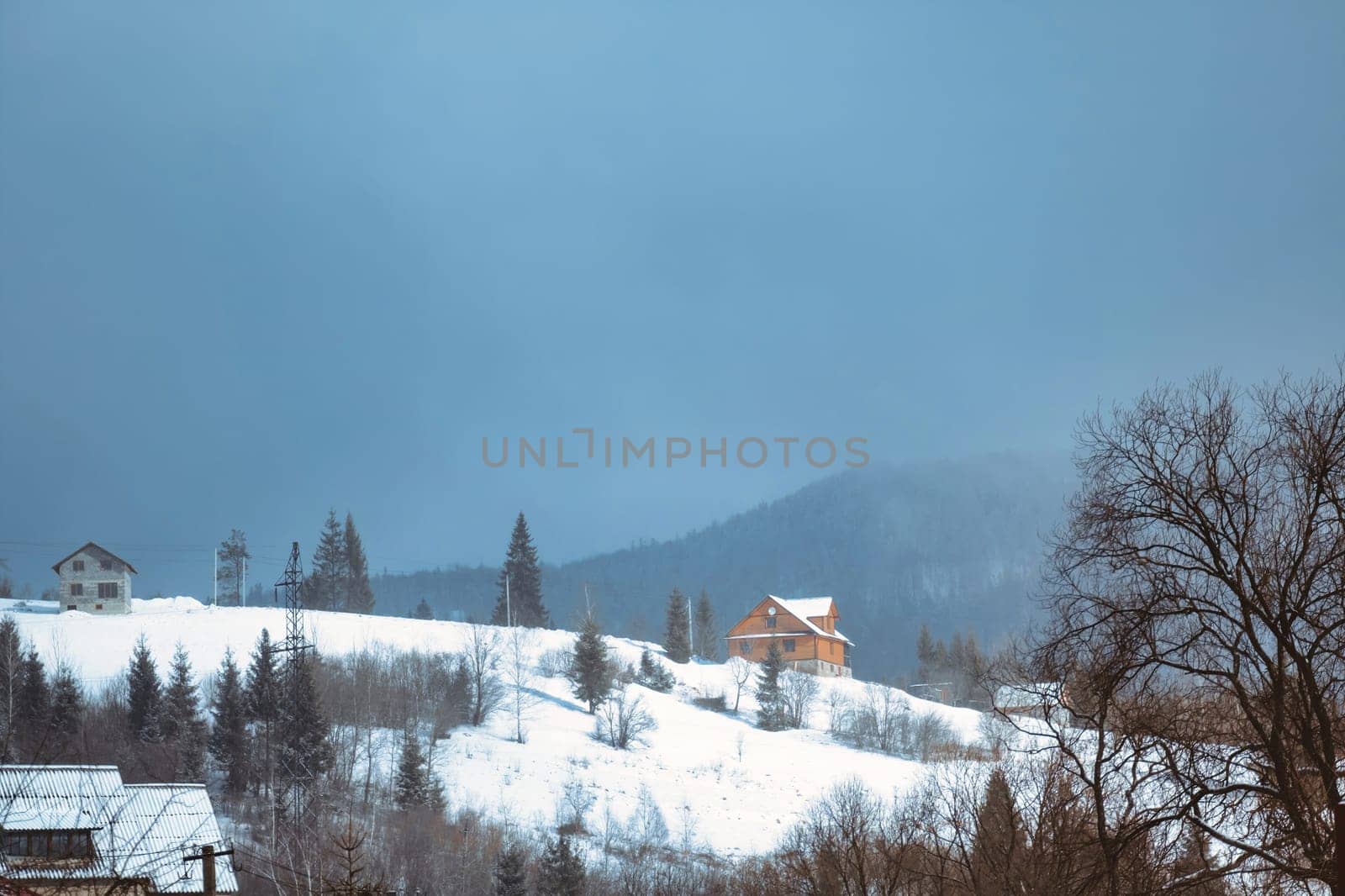 Winter scene house on mountains landscape. Stone snowy mountains. download image