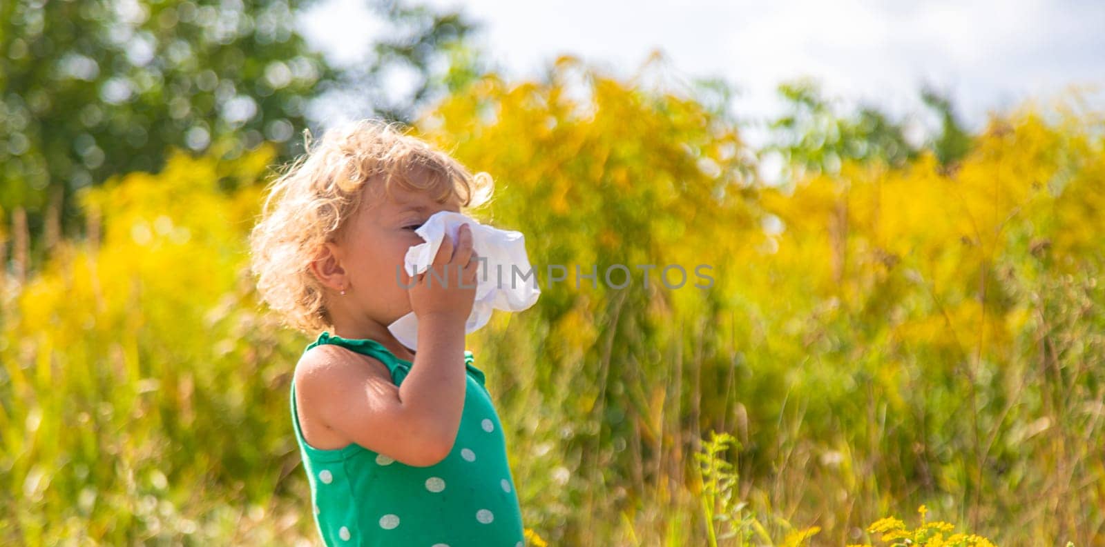 A child is allergic to ragweed blooming in the park. Selective focus. Nature.