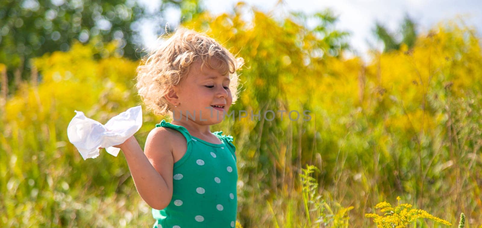 A child is allergic to ragweed blooming in the park. Selective focus. Nature.