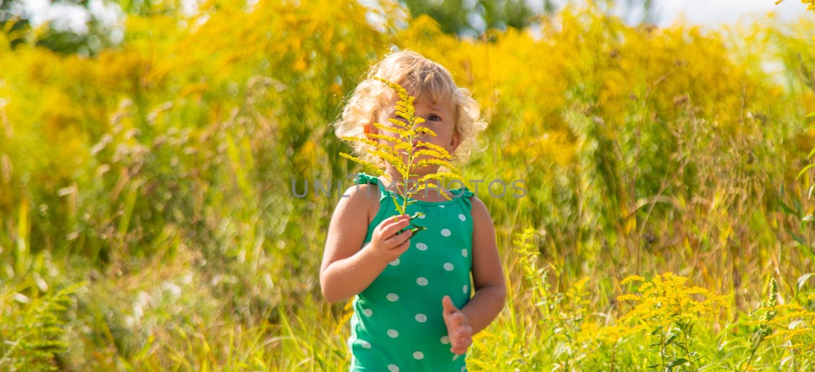 A child is allergic to ragweed blooming in the park. Selective focus. Nature.