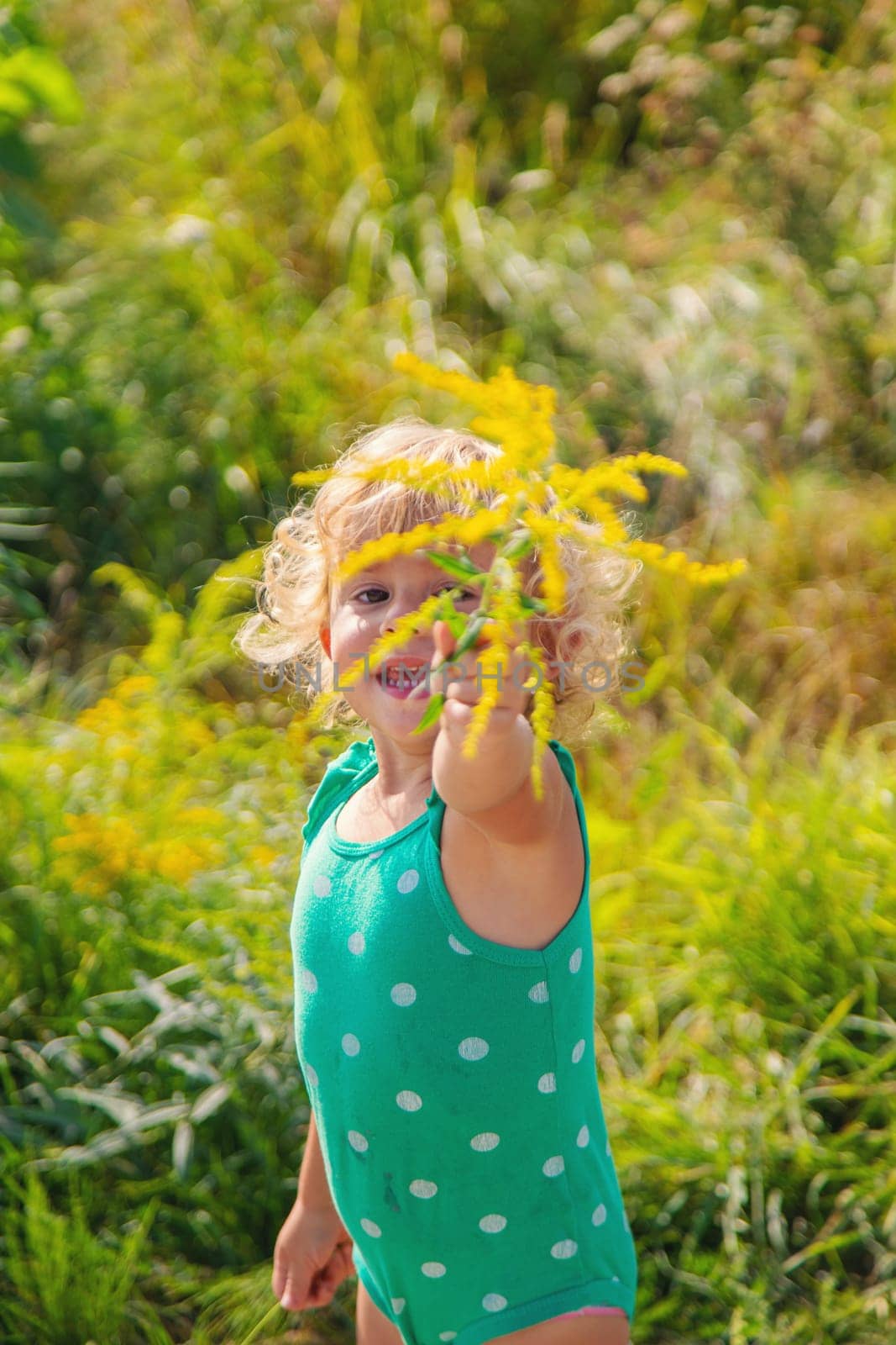 A child is allergic to ragweed blooming in the park. Selective focus. Nature.