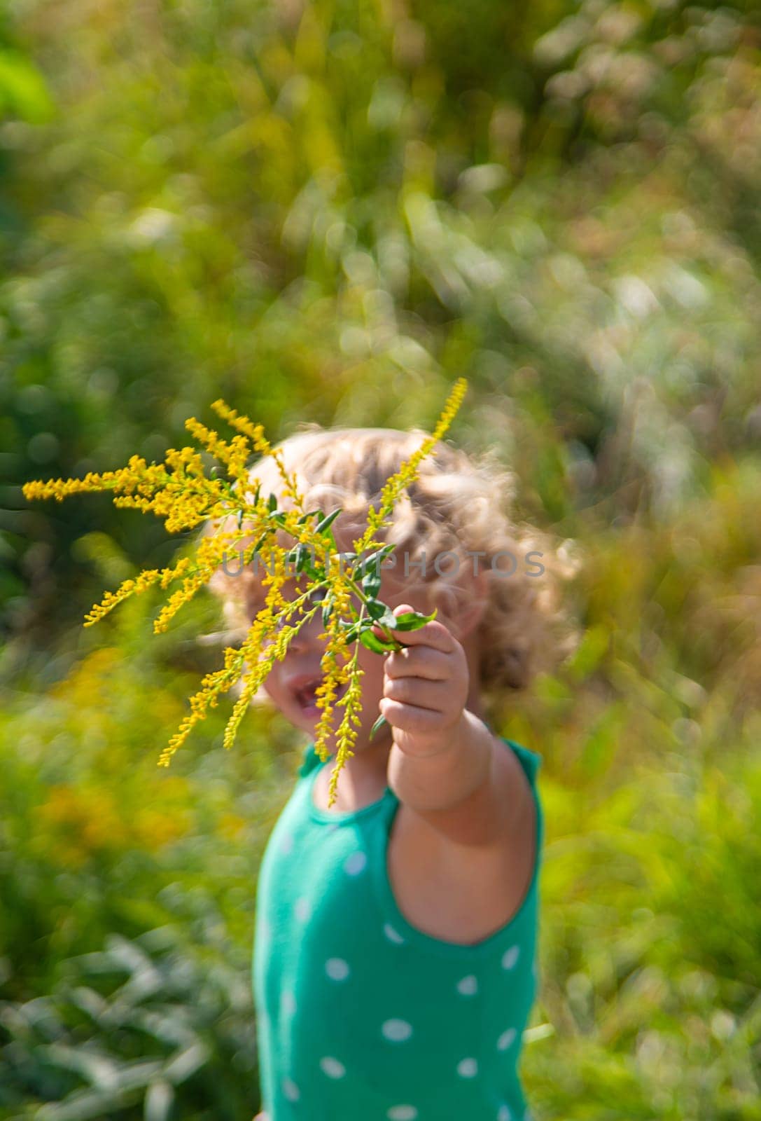 A child is allergic to ragweed blooming in the park. Selective focus. by yanadjana