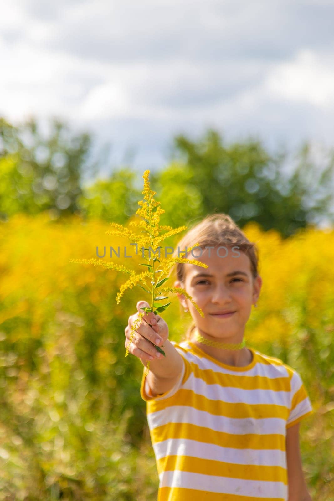 A child is allergic to ragweed blooming in the park. Selective focus. Nature.