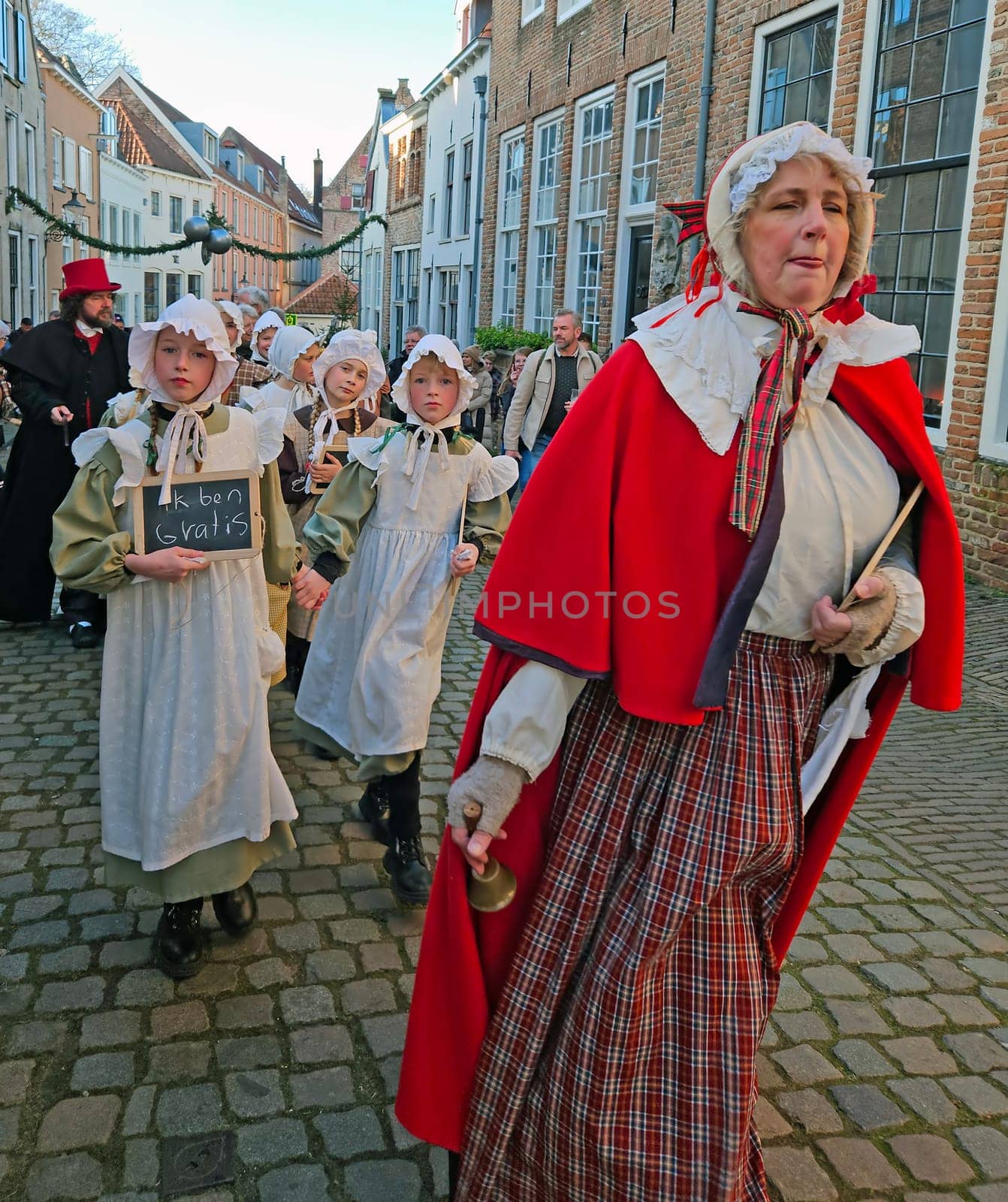 Deventer, Netherlands, December 16, 2023: A school class in the streets of Deventer in victorian style cloting during the Dickens Festival.
