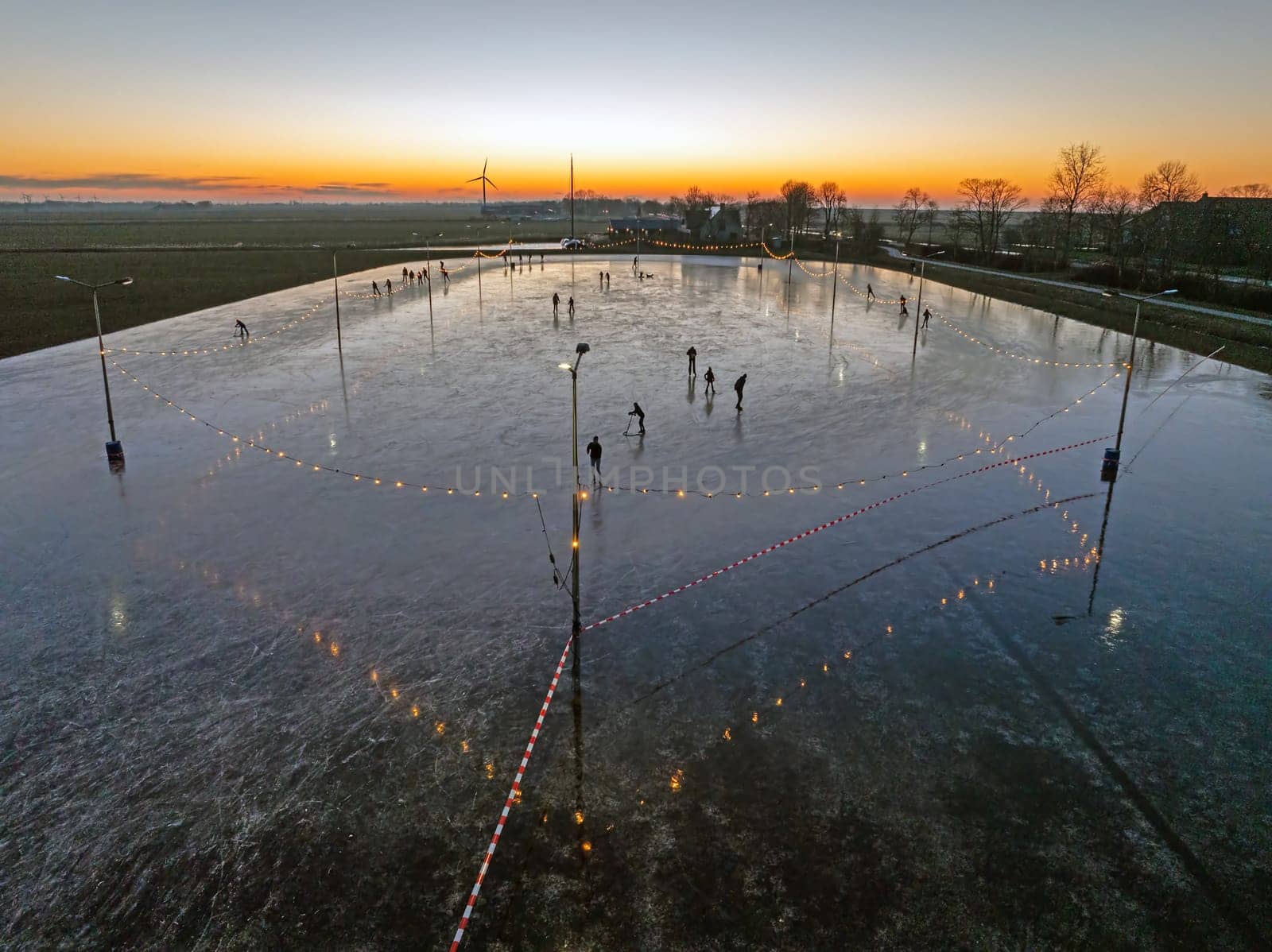 Aerial from ice skating at sunset on the ice rink in Koudum Friesland the Netherlands