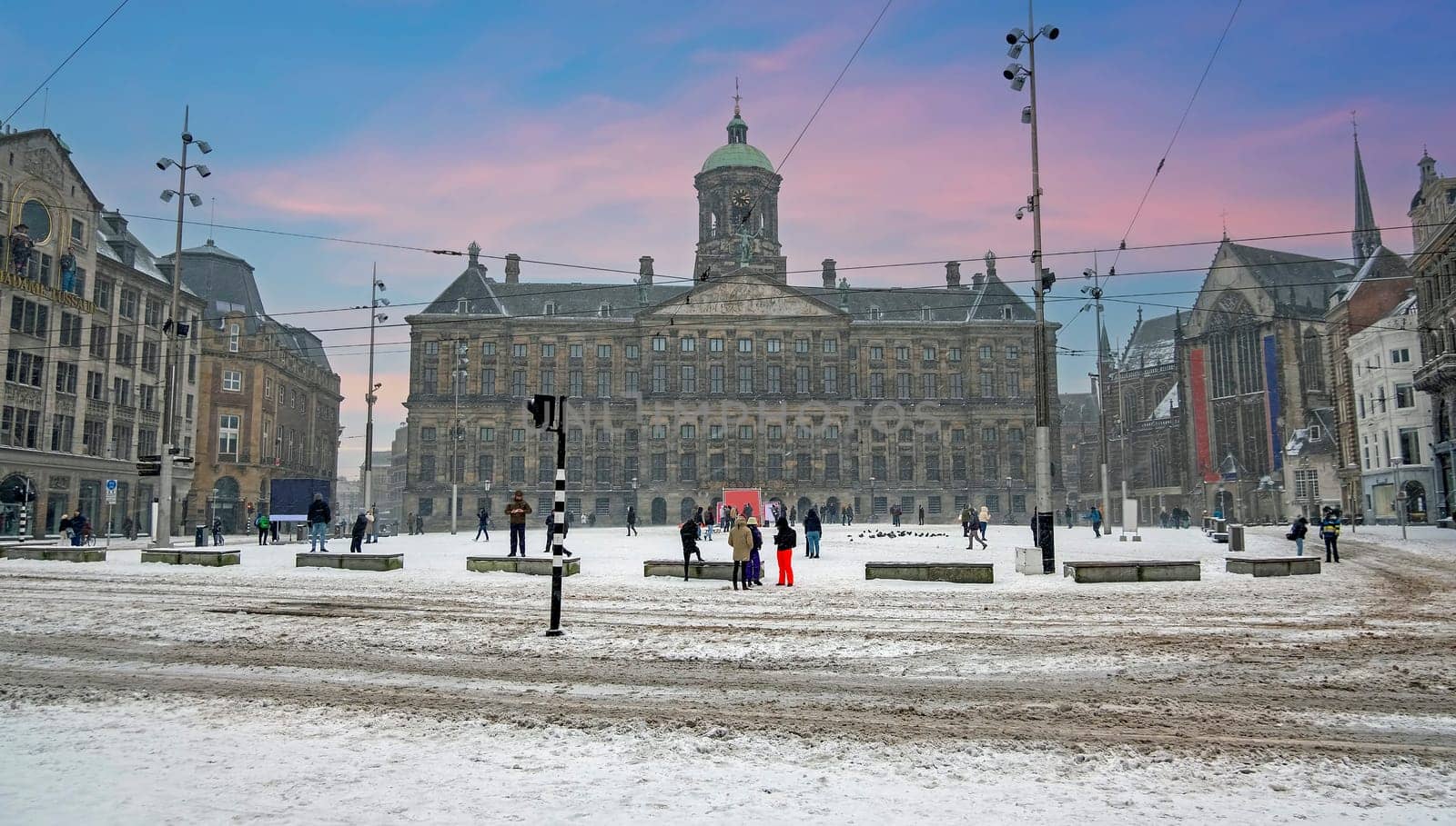 Snowy city Amsterdam at the Dam square in the Netherlands in winter