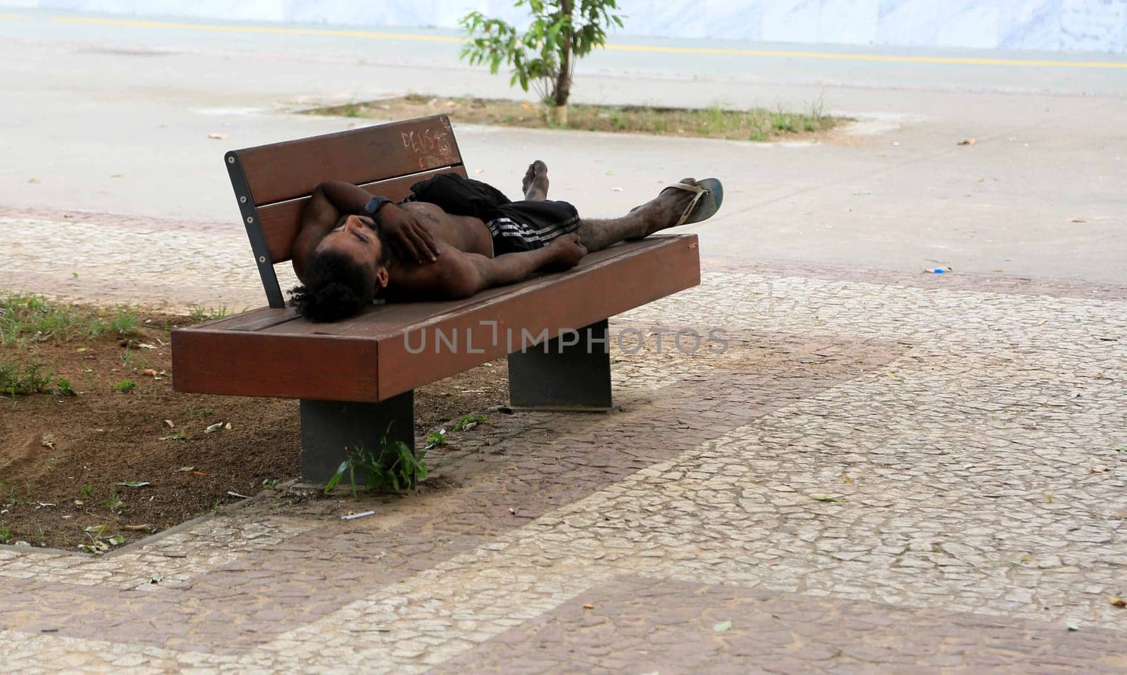 salvador, bahia, brazil - january 5, 2024: beggar sleeping on the street in the city of Salvador