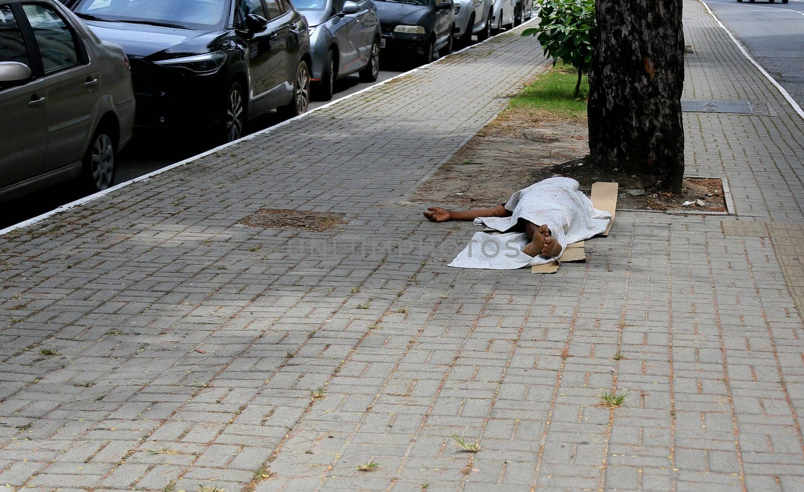 salvador, bahia, brazil - january 5, 2024: beggar sleeping on the street in the city of Salvador