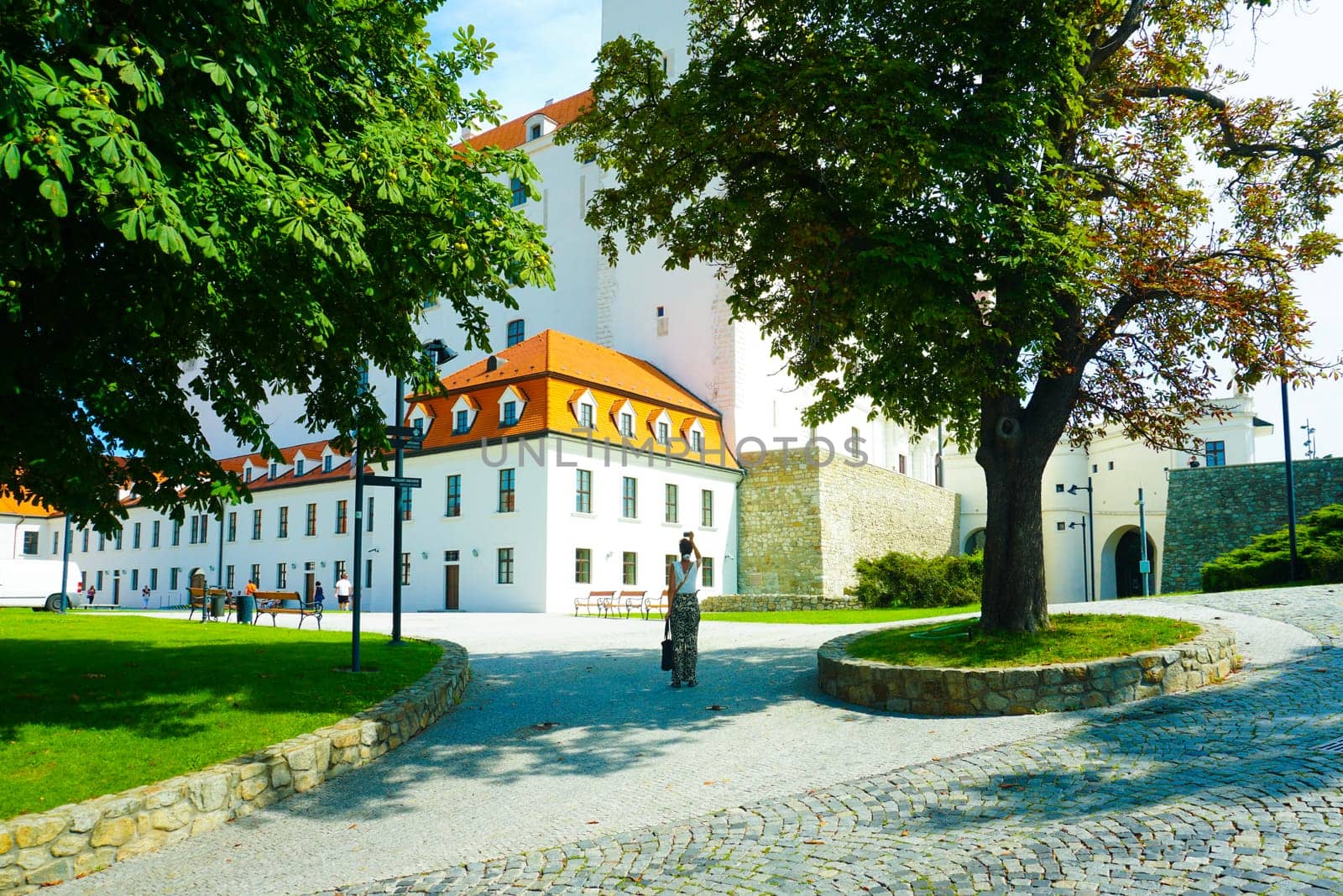 White castle building in Bratislava on a sunny day and a tourist by stan111