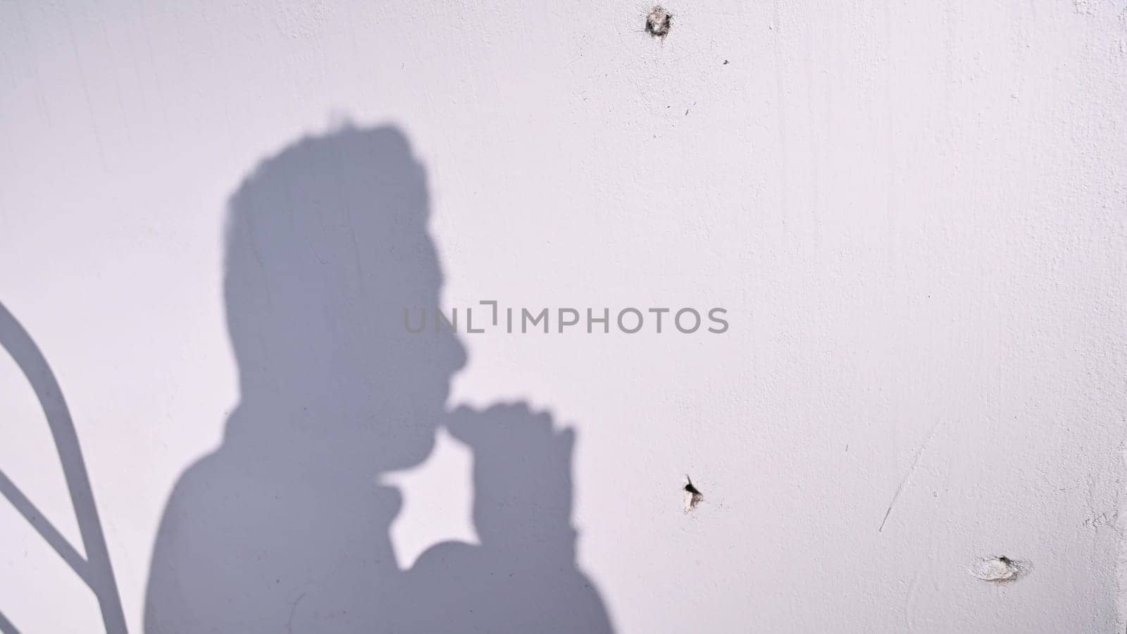 Young man using an e-cigarette on white background. by Peruphotoart