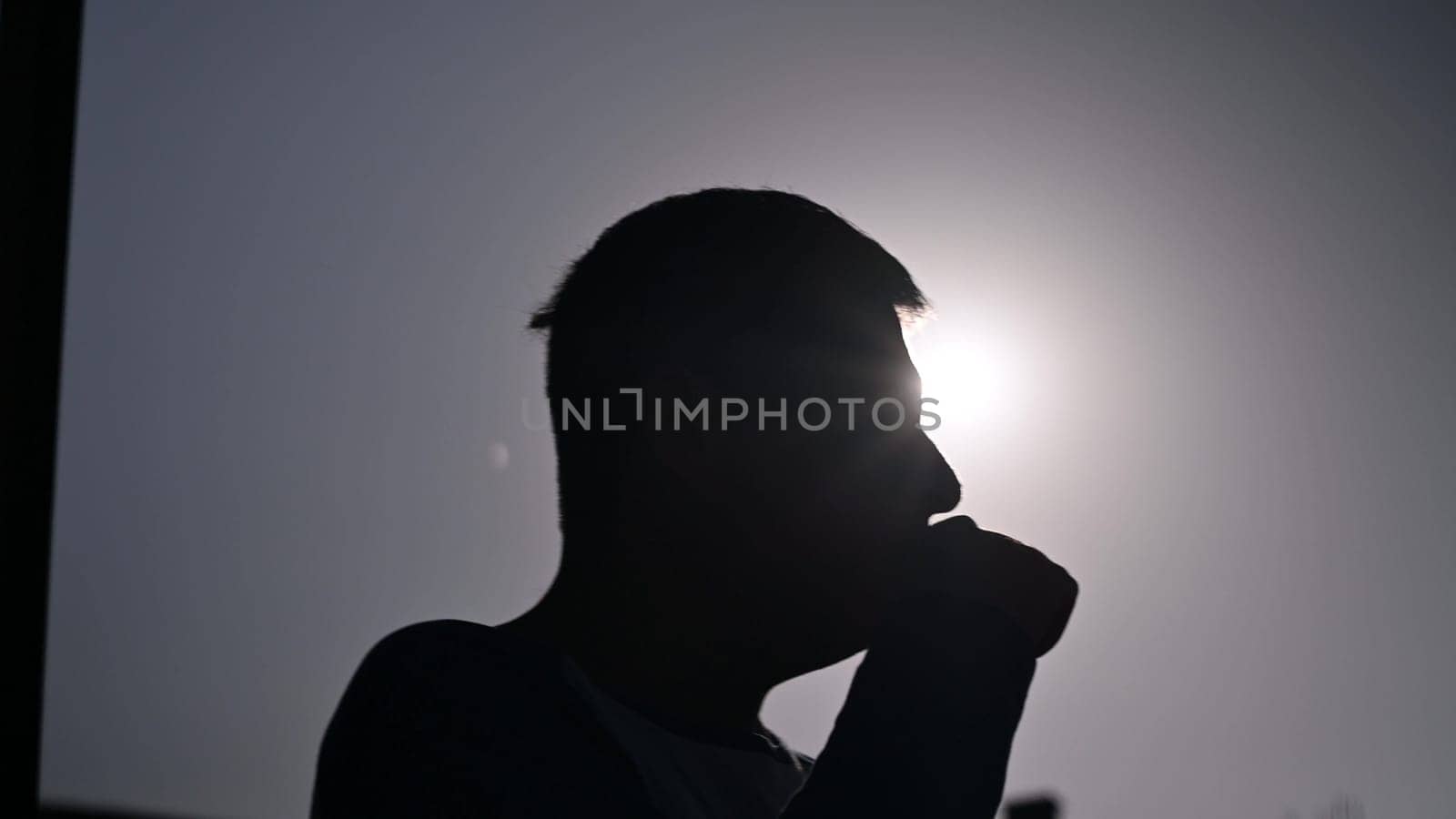 Young man using an e-cigarette on white background. by Peruphotoart