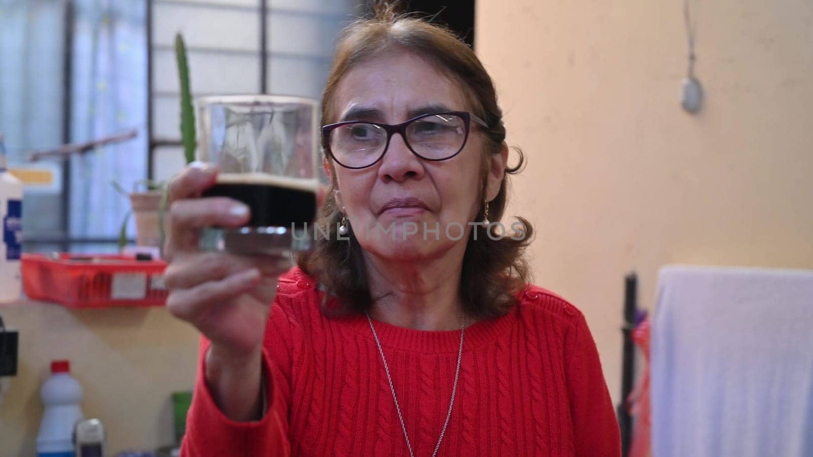 An adult woman dancing and showing off her beer. She is having a good time