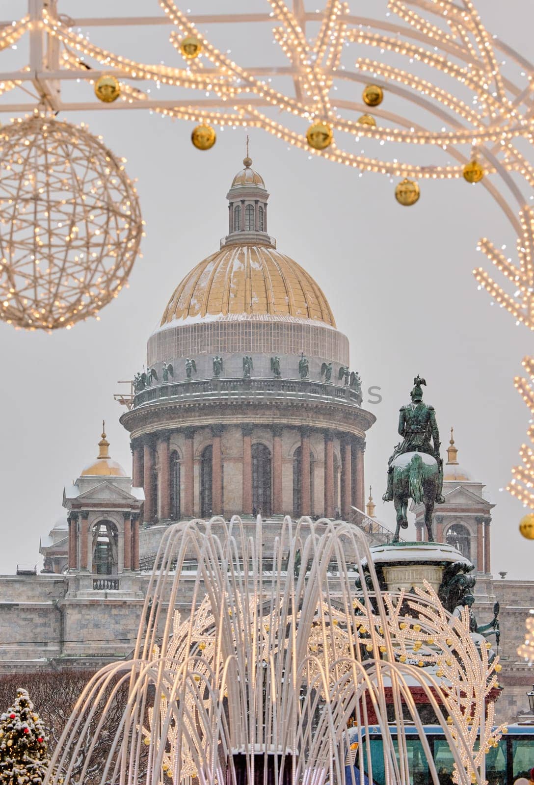 Russia, St Petersburg, St. Isaac's Cathedral and the monument to Emperor Nicholas II through lighting decorations during snowstorm, streets decorated for Christmas by vladimirdrozdin