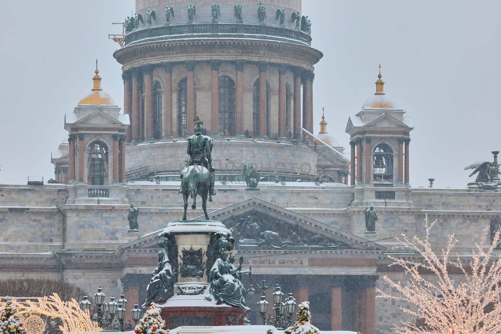 Colonnade of St. Isaac Cathedral and the monument to Emperor Nicholas II during snowstorm in St. Petersburg - Russia. High quality photo