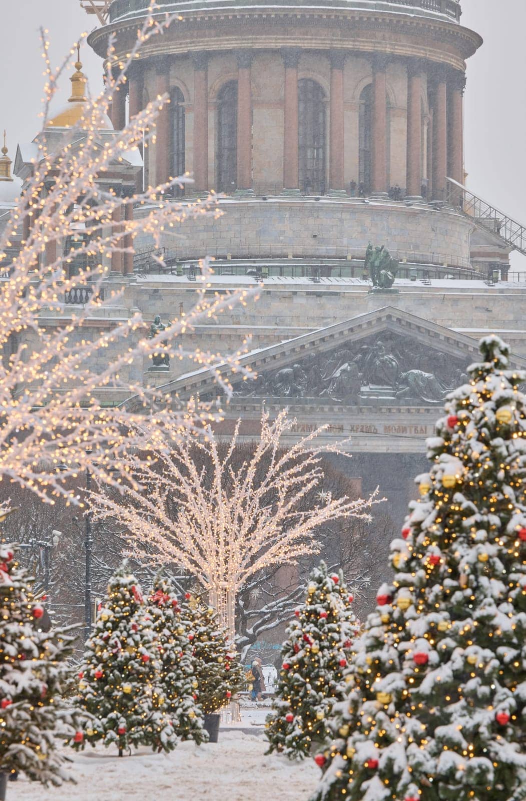 Colonnade of St. Isaac Cathedral and the monument to Emperor Nicholas II during snowstorm in St. Petersburg - Russia. High quality photo