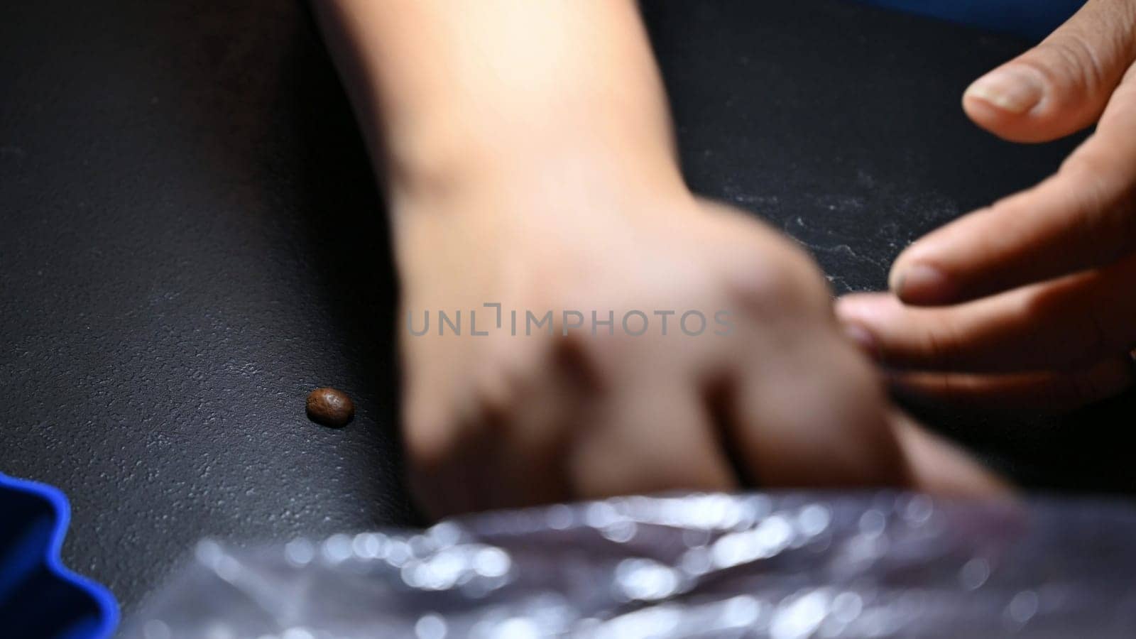Woman's hands selecting fresh and aromatic roasted coffee beans. Fresh Roasted Coffee Beans