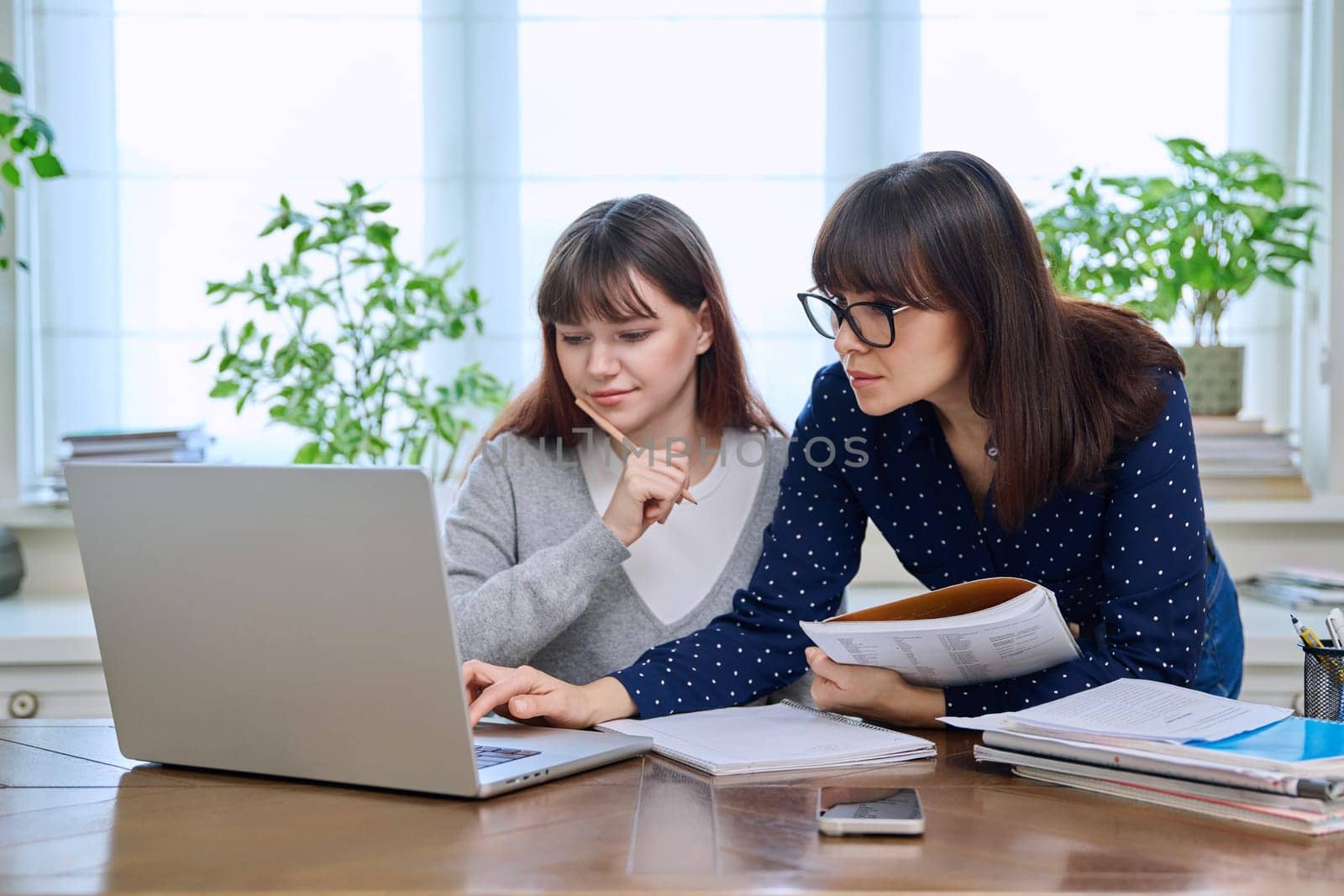 Teenage student studying at desk with computer, trainer mentor helping teaching by VH-studio