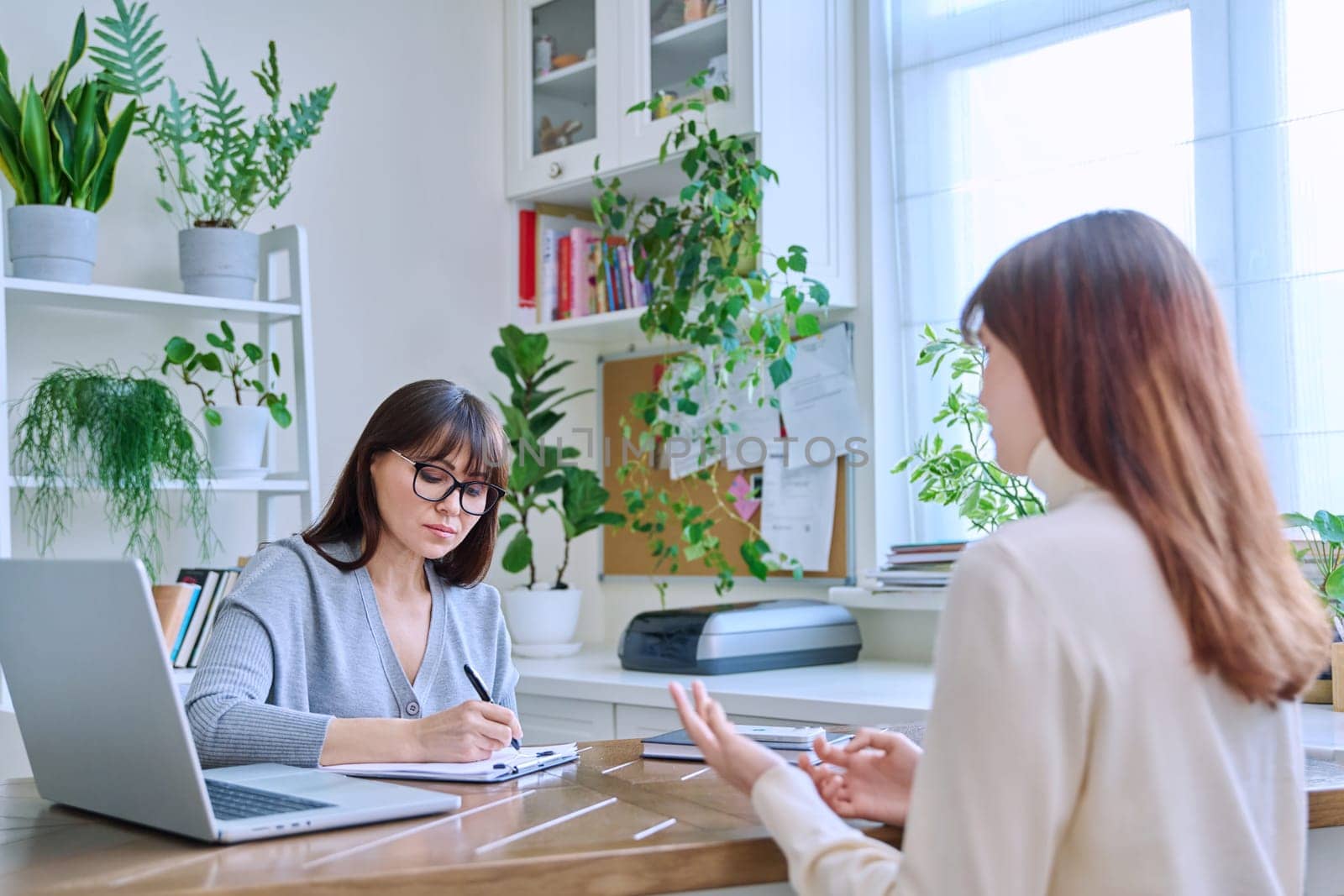 Young female college student at meeting with professional mental therapist by VH-studio