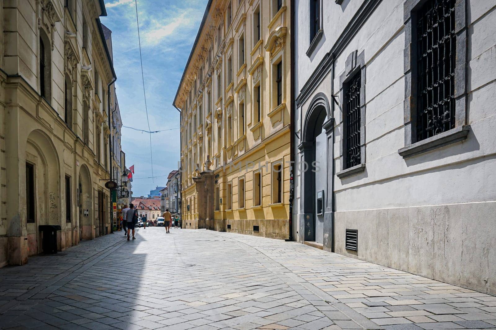 Bratislava, Slovakia, August 25, 2023: Venturska street in the old town of Bratislava on a sunny day and tourists in the distance