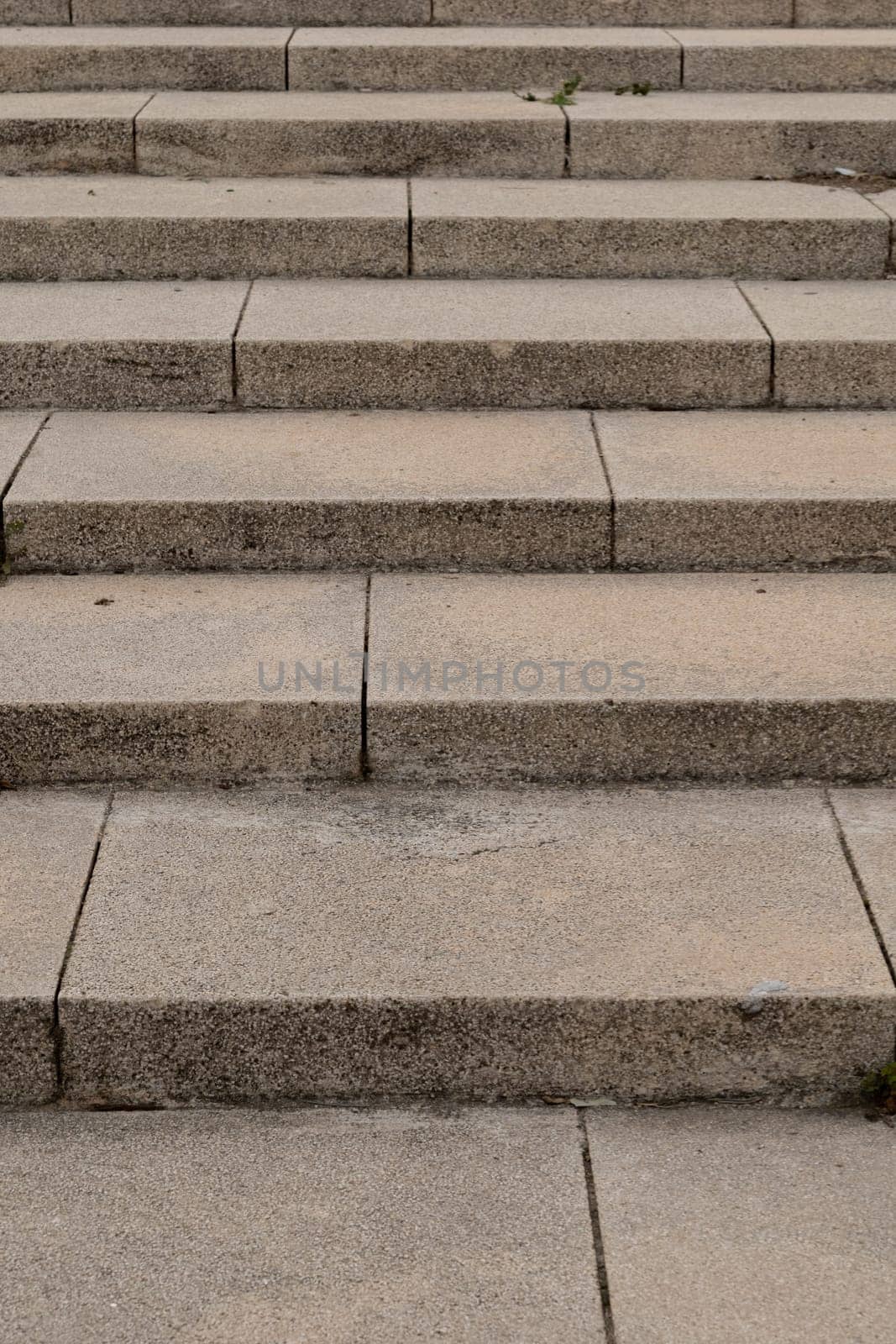 A detailed view of a rectangular set of stone stairs, showcasing the beige brickwork and the sturdy building material.