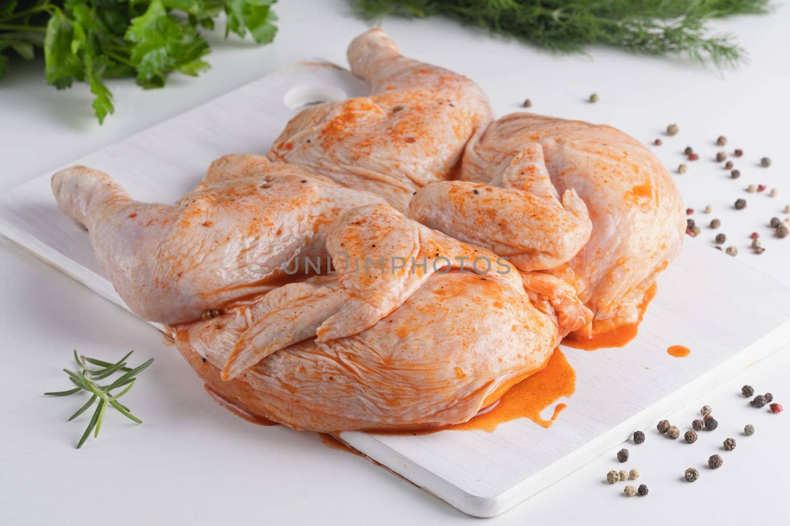 Whole chicken carcass with seasonings on white background for your meat menu or booklet design.