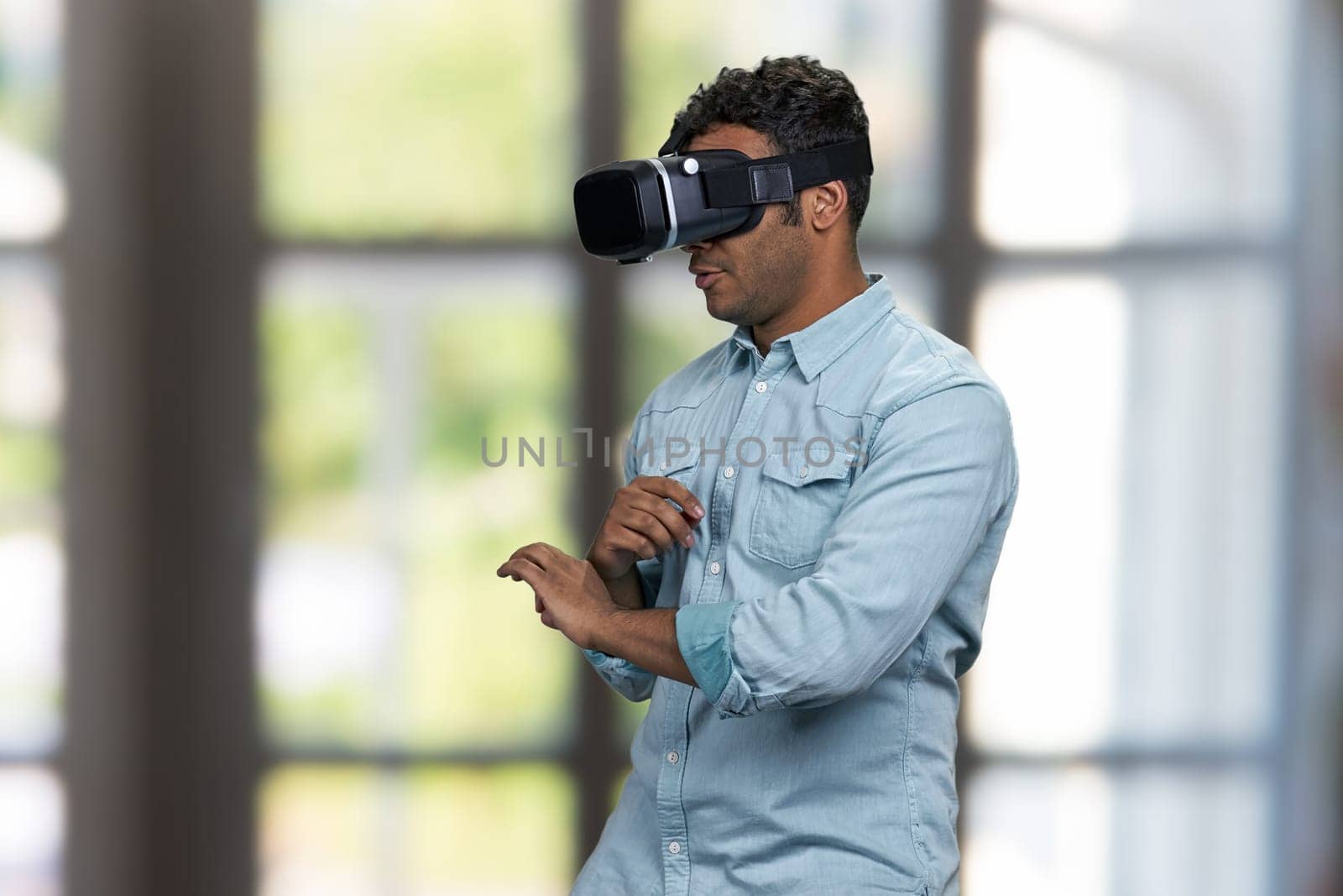 Young african-american guy wearing vr glasses. Future technology concept.