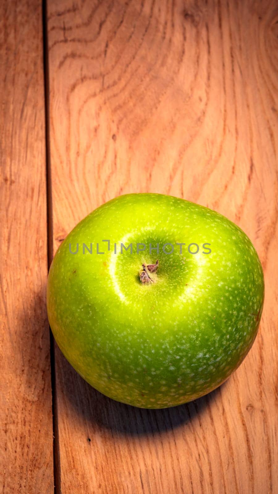 Tasty organic green juicy green apples on a rustic wooden background by vladispas
