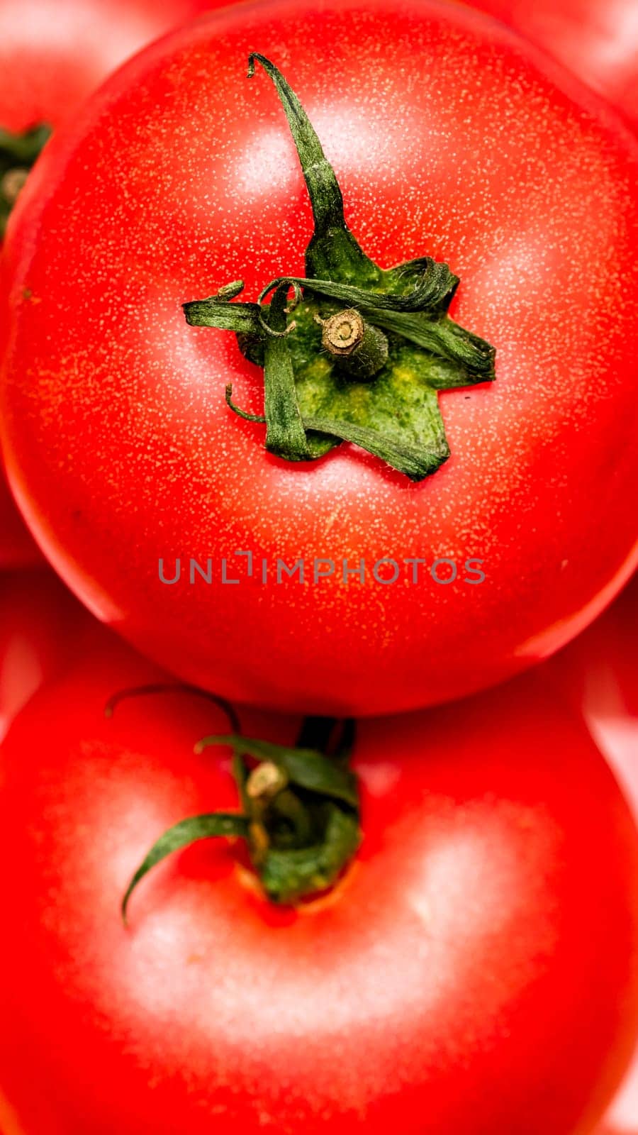Close up of ripe red tomato, tomatoes background. by vladispas
