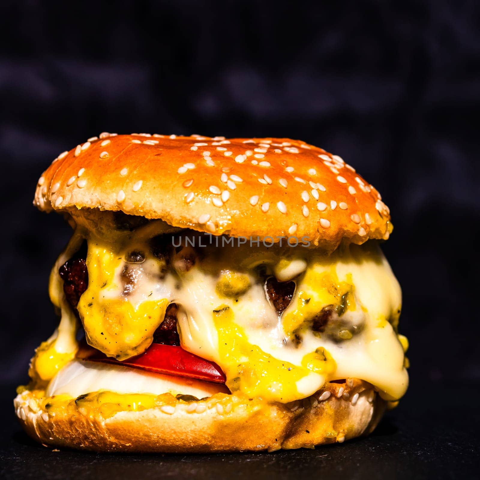 Tasty home made cheeseburger. Cheese burger with pickles, tomatoes, onion, melting cheese