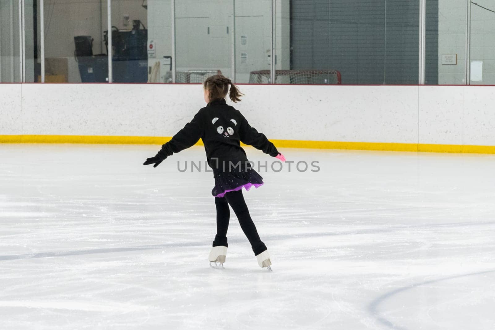 Figure skating practice at an indoor skating rink by arinahabich